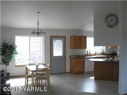 830 Hideaway Road Yakima, WA 98908 - Photo 4 of 13 a kitchen with granite countertop a stove a sink dishwasher and white cabinets with wooden floor