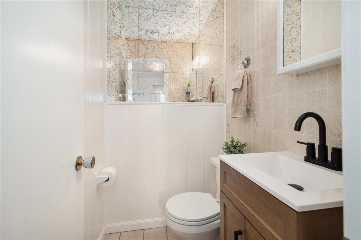 412 Milky Way Lompoc, CA 93436 - Photo 12 of 40 a bathroom with a toilet sink and mirror