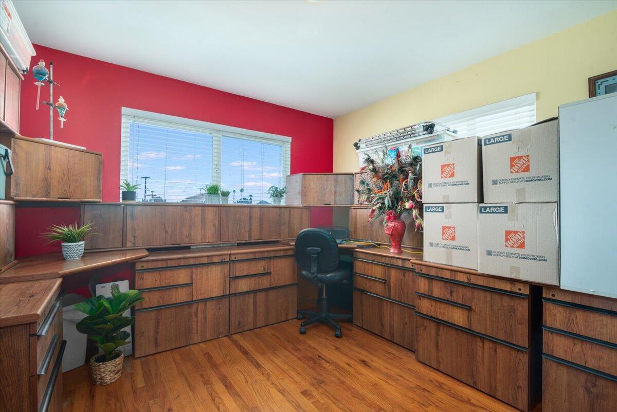 412 Milky Way Lompoc, CA 93436 - Photo 18 of 40 a kitchen with granite countertop a white refrigerator oven a sink and dishwasher with wooden floor