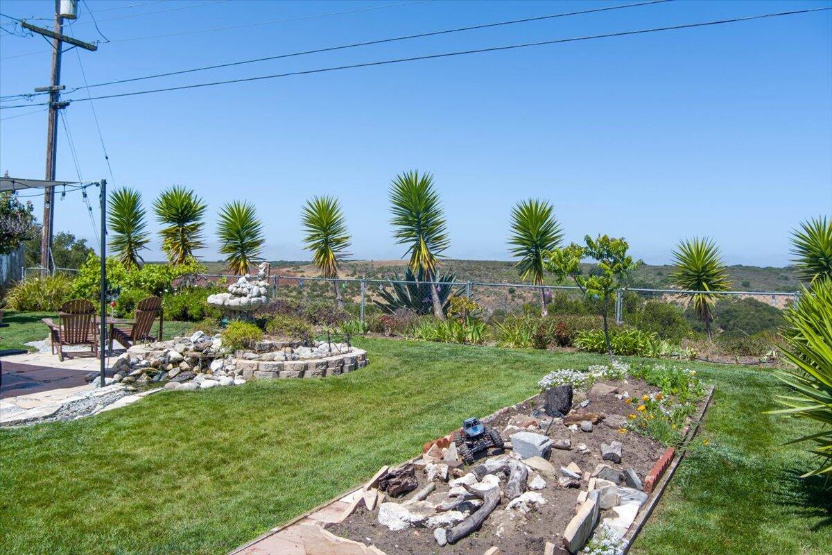 412 Milky Way Lompoc, CA 93436 - Photo 23 of 40 a view of a garden with a table and chairs