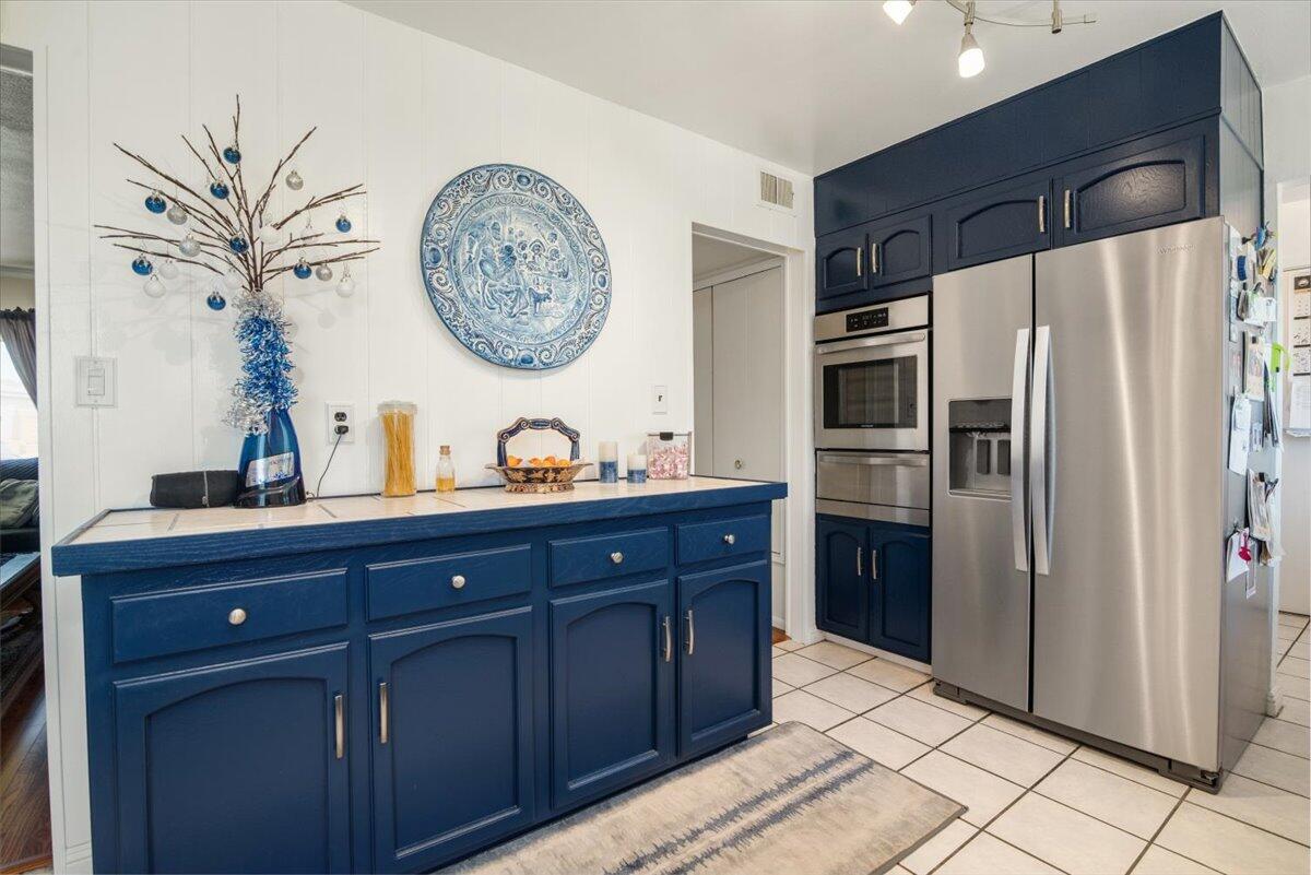 412 Milky Way Lompoc, CA 93436 - Photo 9 of 40 a kitchen with stainless steel appliances granite countertop a refrigerator and a cabinets