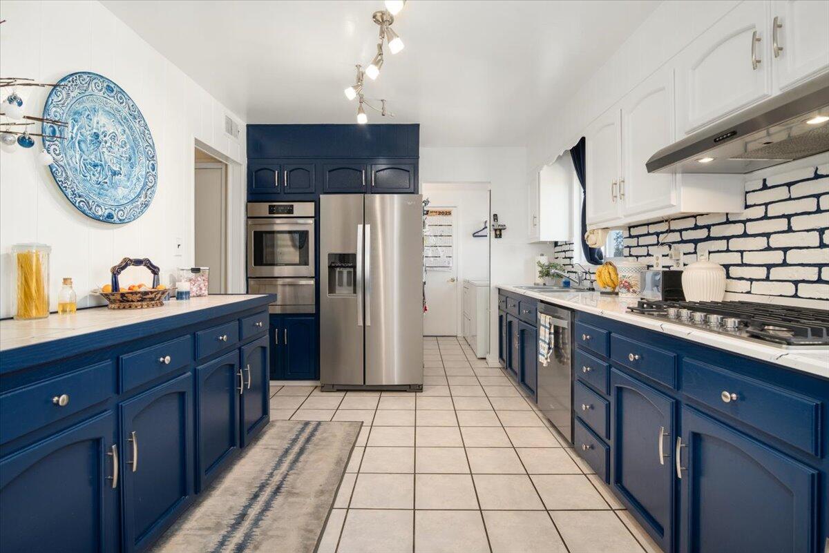 412 Milky Way Lompoc, CA 93436 - Photo 10 of 40 a large kitchen with stainless steel appliances granite countertop a refrigerator and a stove top oven