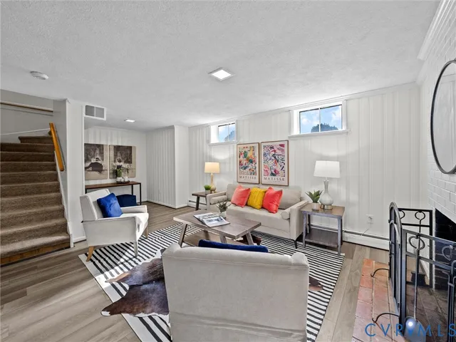 a living room with furniture and wooden floor