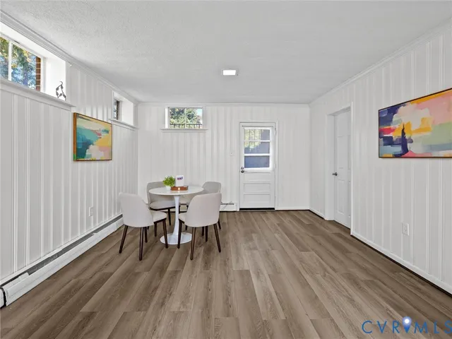 a view of a dining room with furniture and wooden floor
