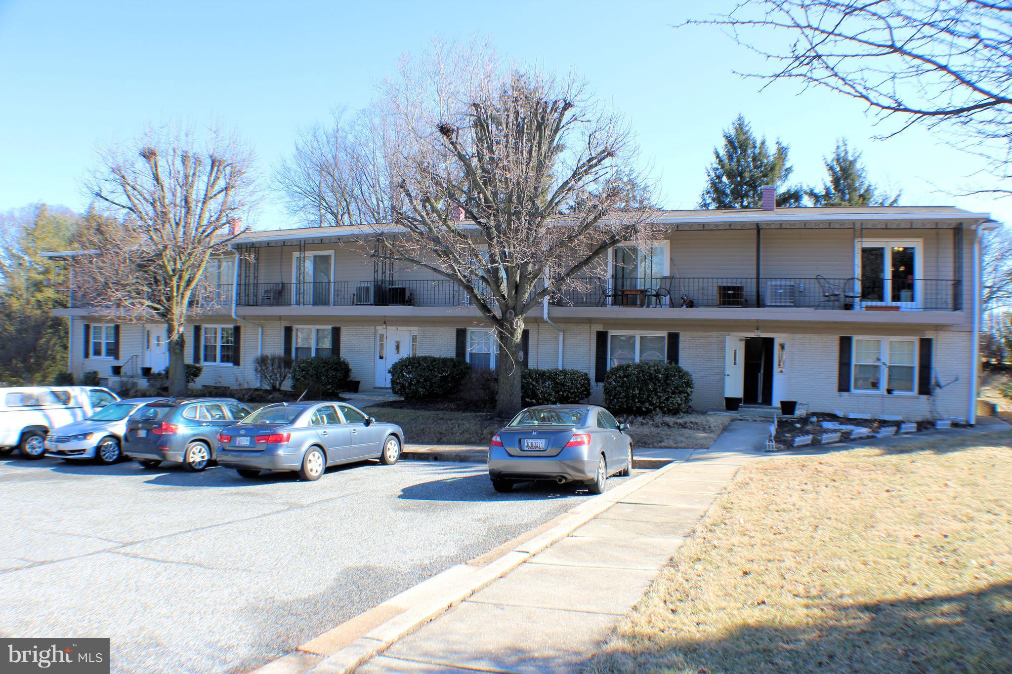 1 Center Road, Unit B4 Towson, MD 21286 - Photo 1 of 16 a front view of a building with cars parked