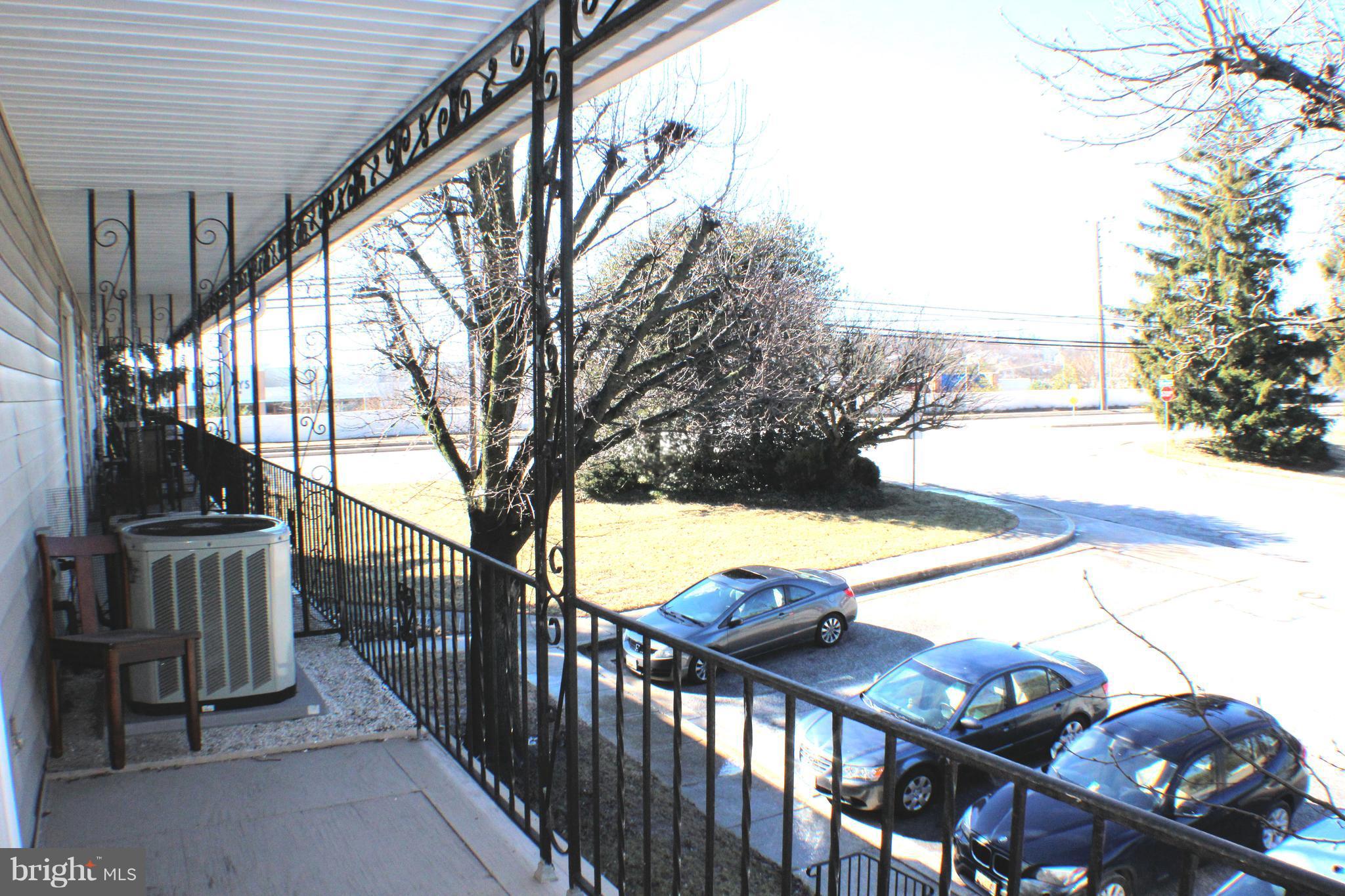 1 Center Road, Unit B4 Towson, MD 21286 - Photo 14 of 16 a view of a balcony with wooden floor