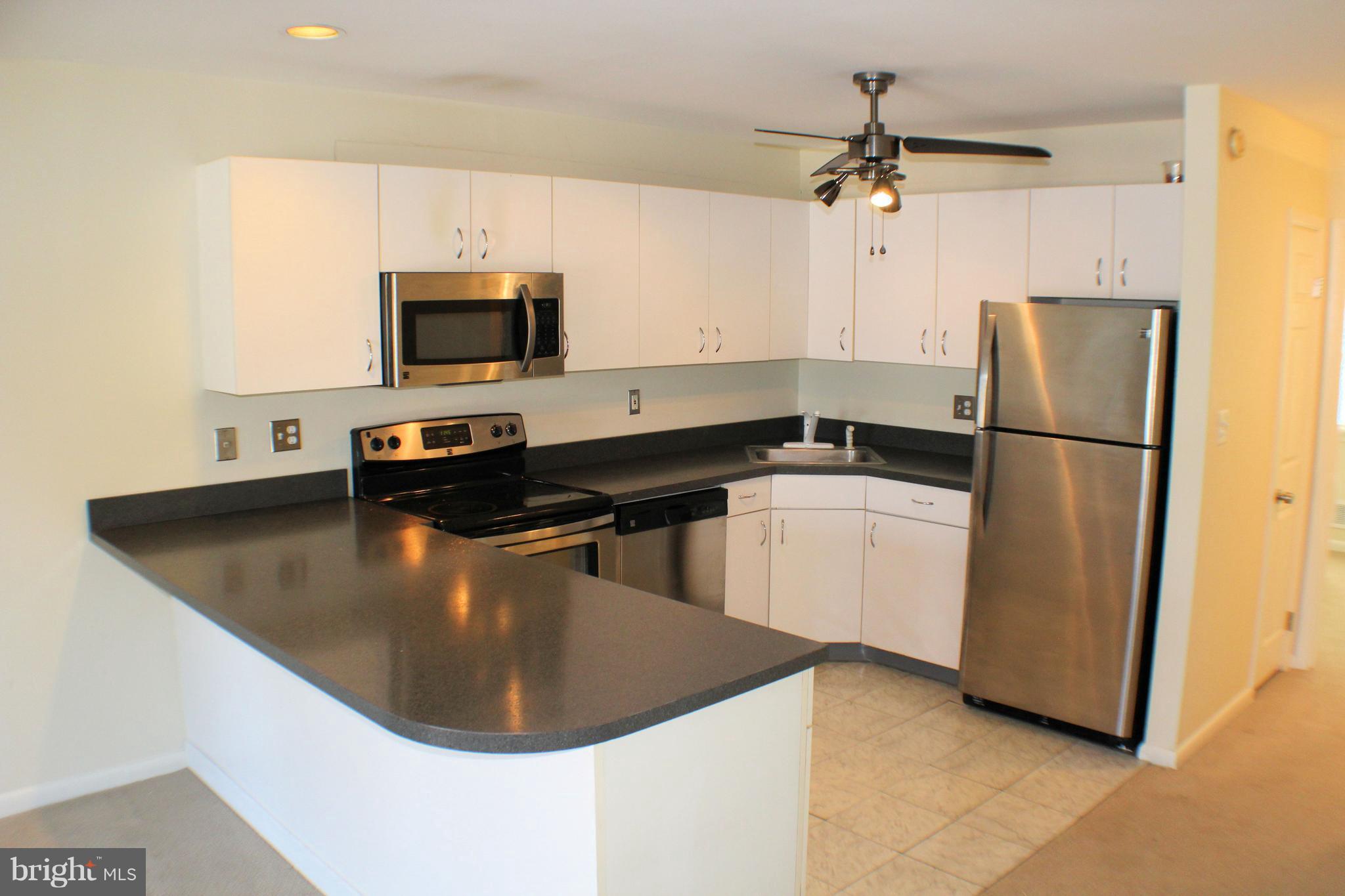 1 Center Road, Unit B4 Towson, MD 21286 - Photo 5 of 16 a kitchen with a refrigerator a sink and a stove