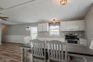 a kitchen with kitchen island a stove a sink and a cabinets