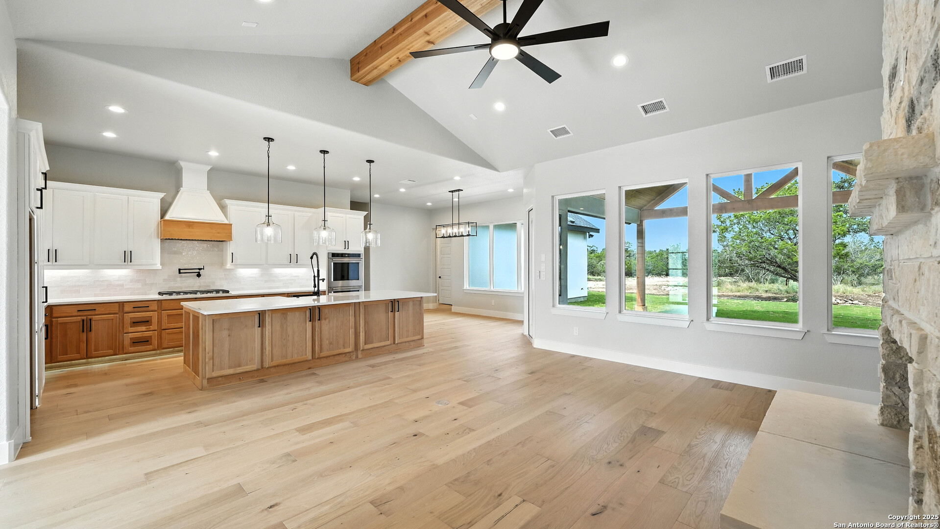 306 Toucan Drive Spring Branch, TX 78070 - Photo 12 of 50 a large kitchen with stainless steel appliances kitchen island a large counter top and wooden floors