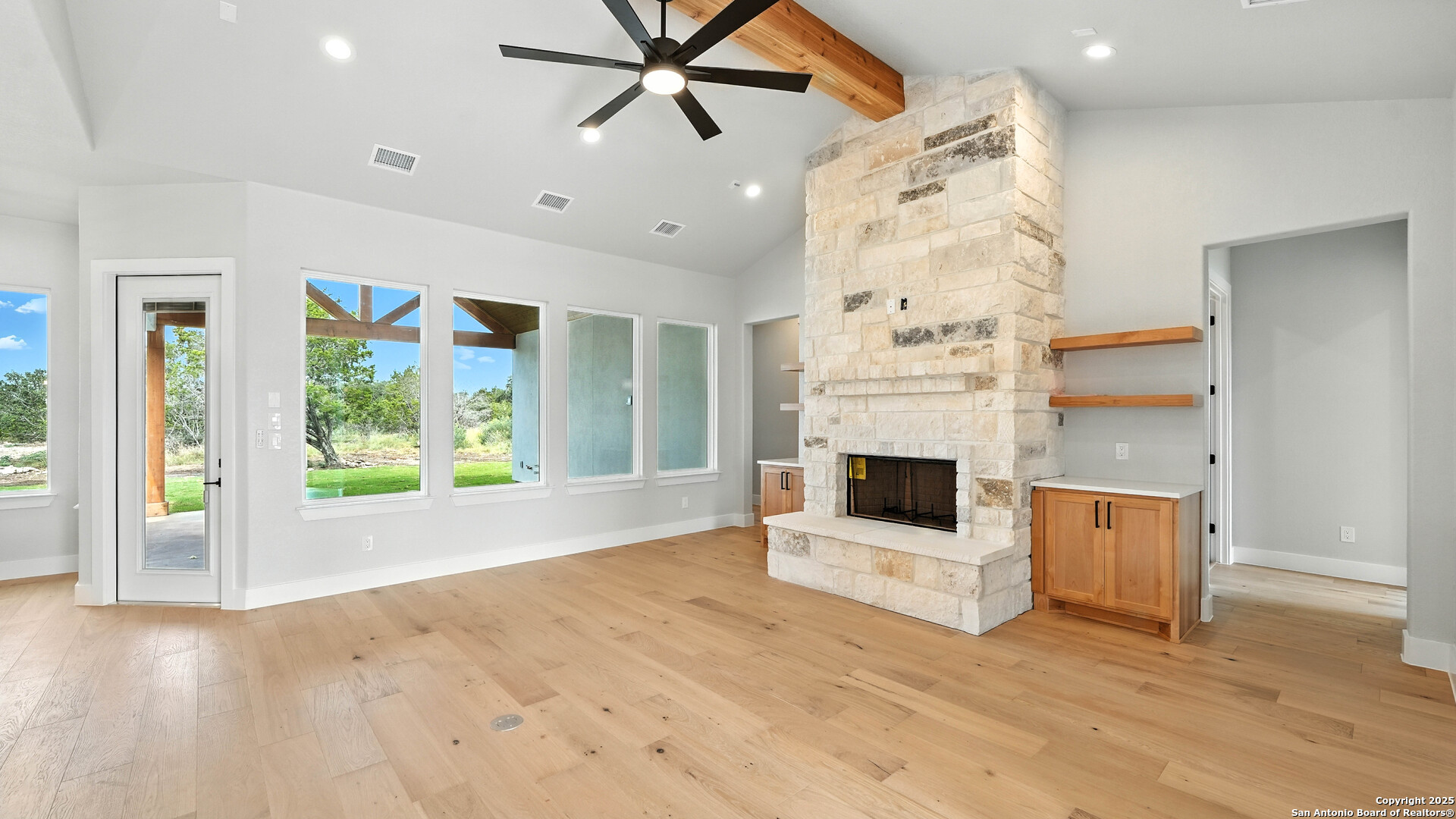 306 Toucan Drive Spring Branch, TX 78070 - Photo 13 of 50 a view of a livingroom with a fireplace a ceiling fan and windows