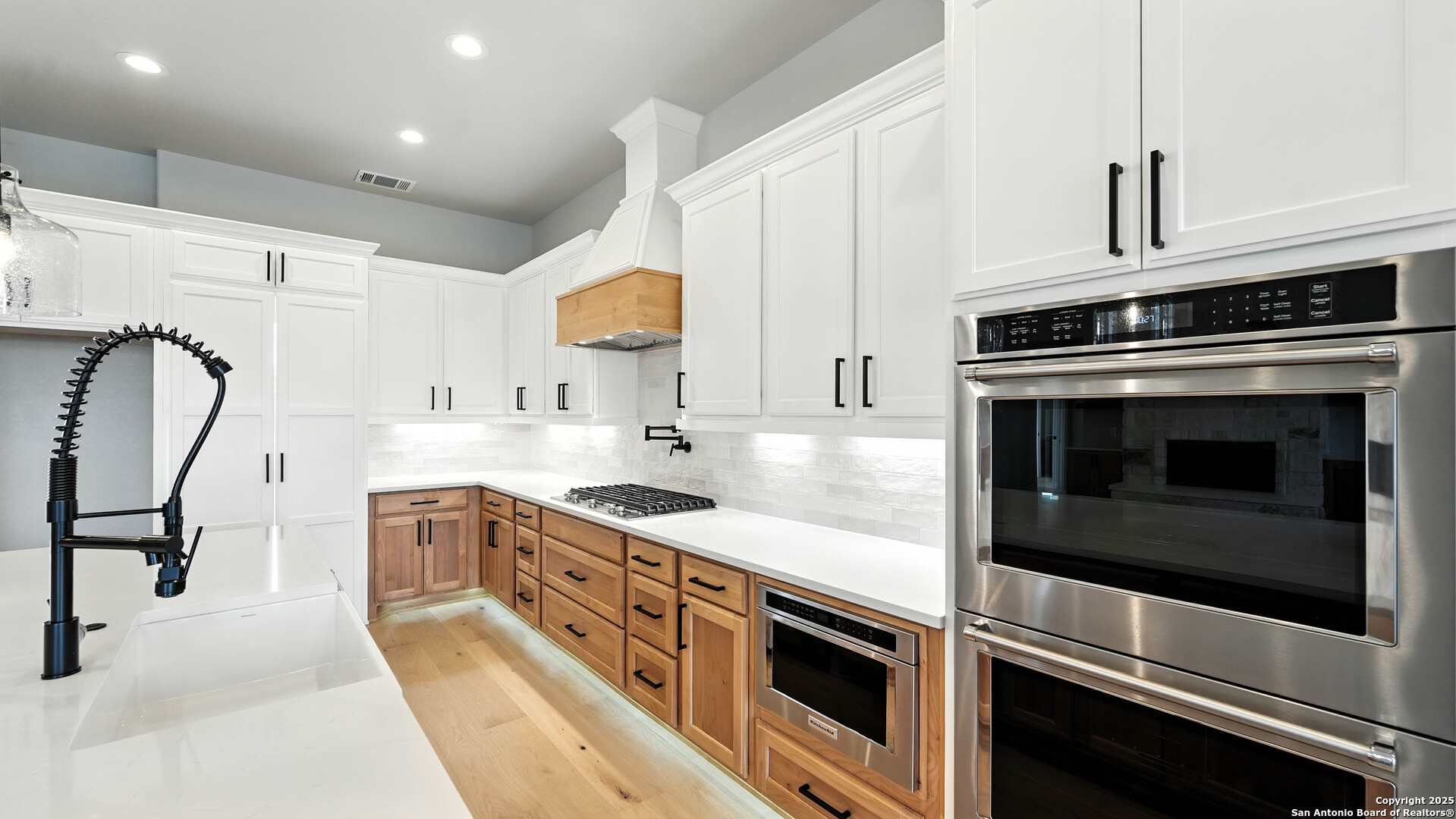 306 Toucan Drive Spring Branch, TX 78070 - Photo 17 of 50 a kitchen with stainless steel appliances white cabinets a sink stove and microwave