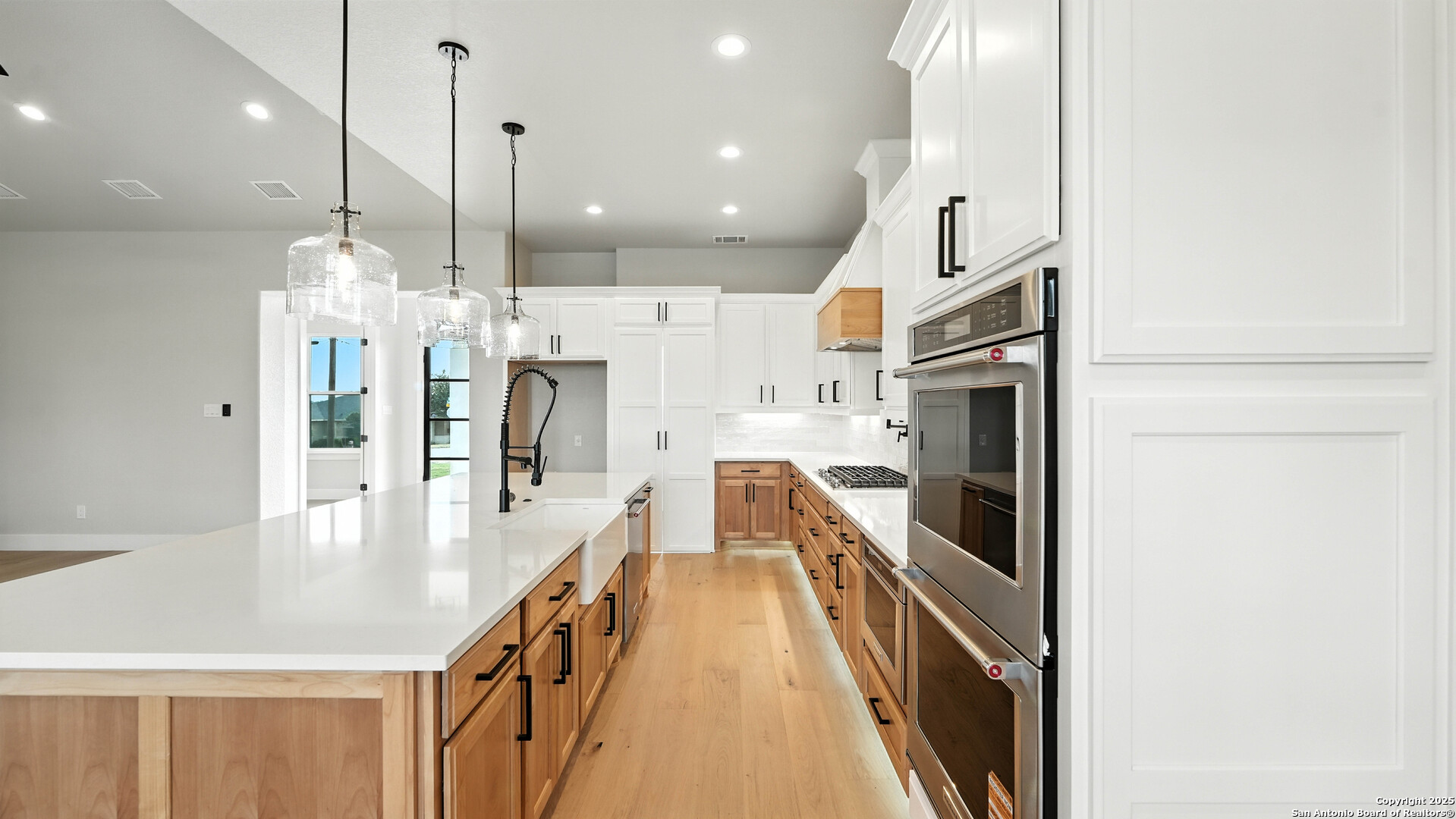 306 Toucan Drive Spring Branch, TX 78070 - Photo 20 of 50 a kitchen with stainless steel appliances kitchen island granite countertop a refrigerator a stove and a sink with wooden floor