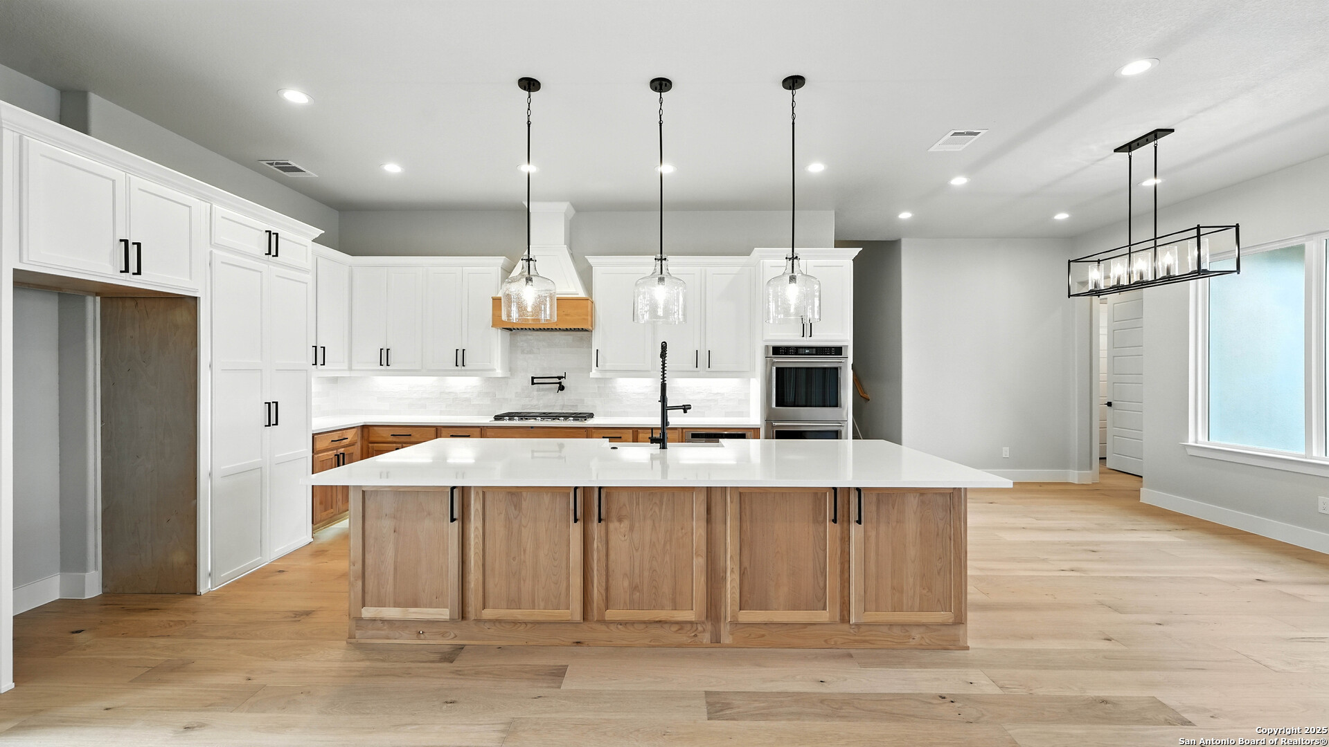 306 Toucan Drive Spring Branch, TX 78070 - Photo 22 of 50 a large kitchen with stainless steel appliances kitchen island granite countertop a refrigerator a oven and a wooden floors