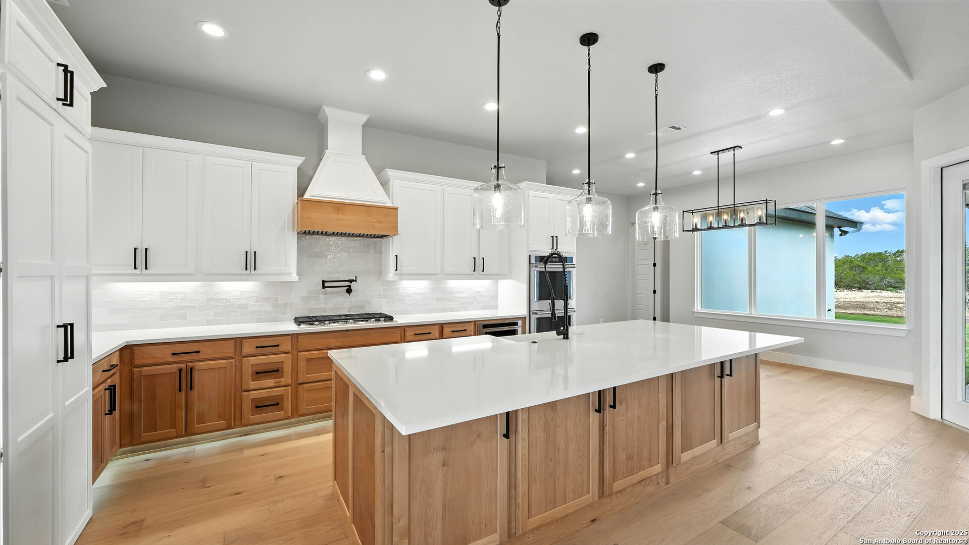 306 Toucan Drive Spring Branch, TX 78070 - Photo 23 of 50 a kitchen with stainless steel appliances granite countertop a sink a stove and a wooden floors