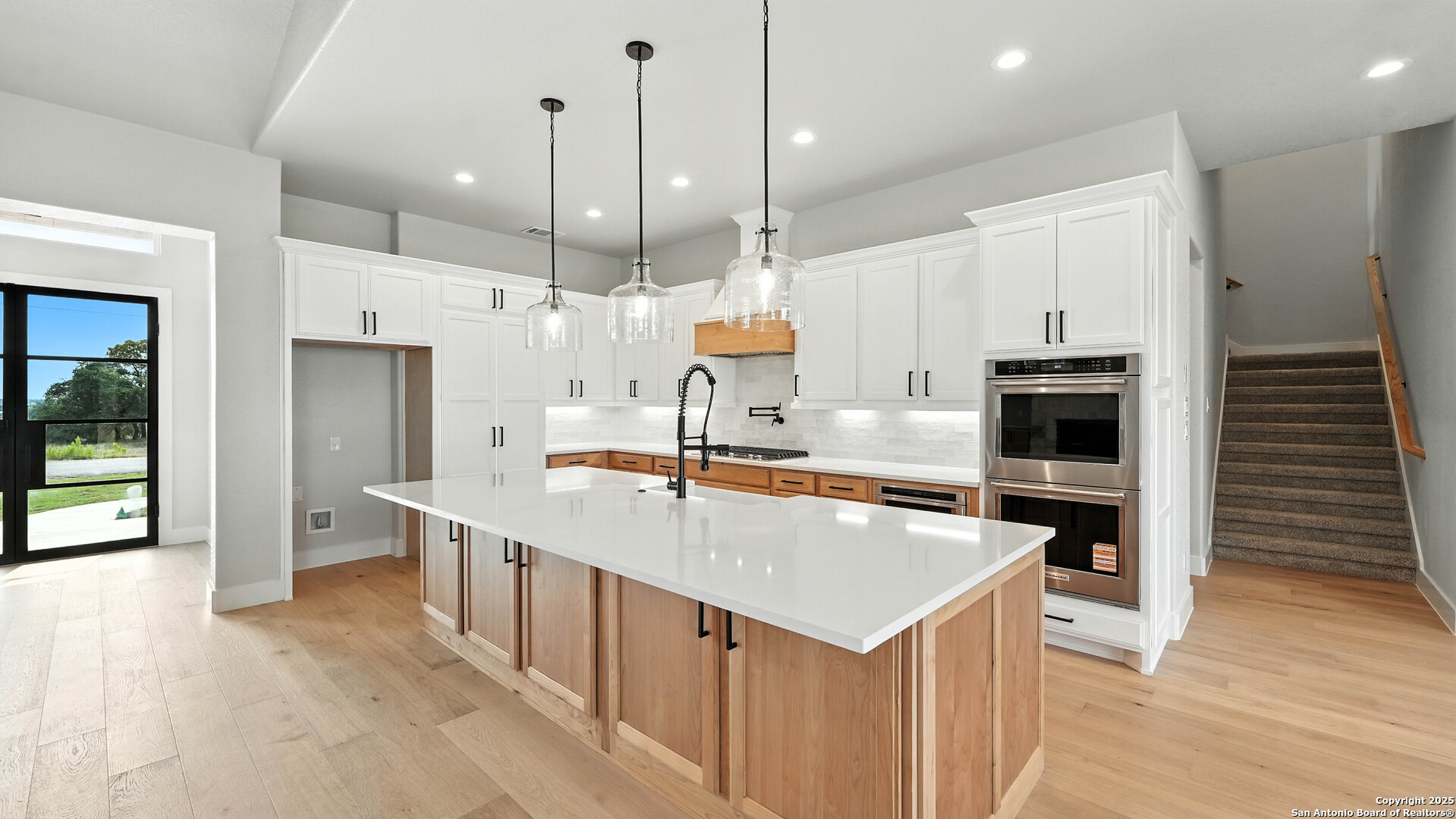 306 Toucan Drive Spring Branch, TX 78070 - Photo 24 of 50 a large kitchen with kitchen island a stove a sink a refrigerator and a wooden floor