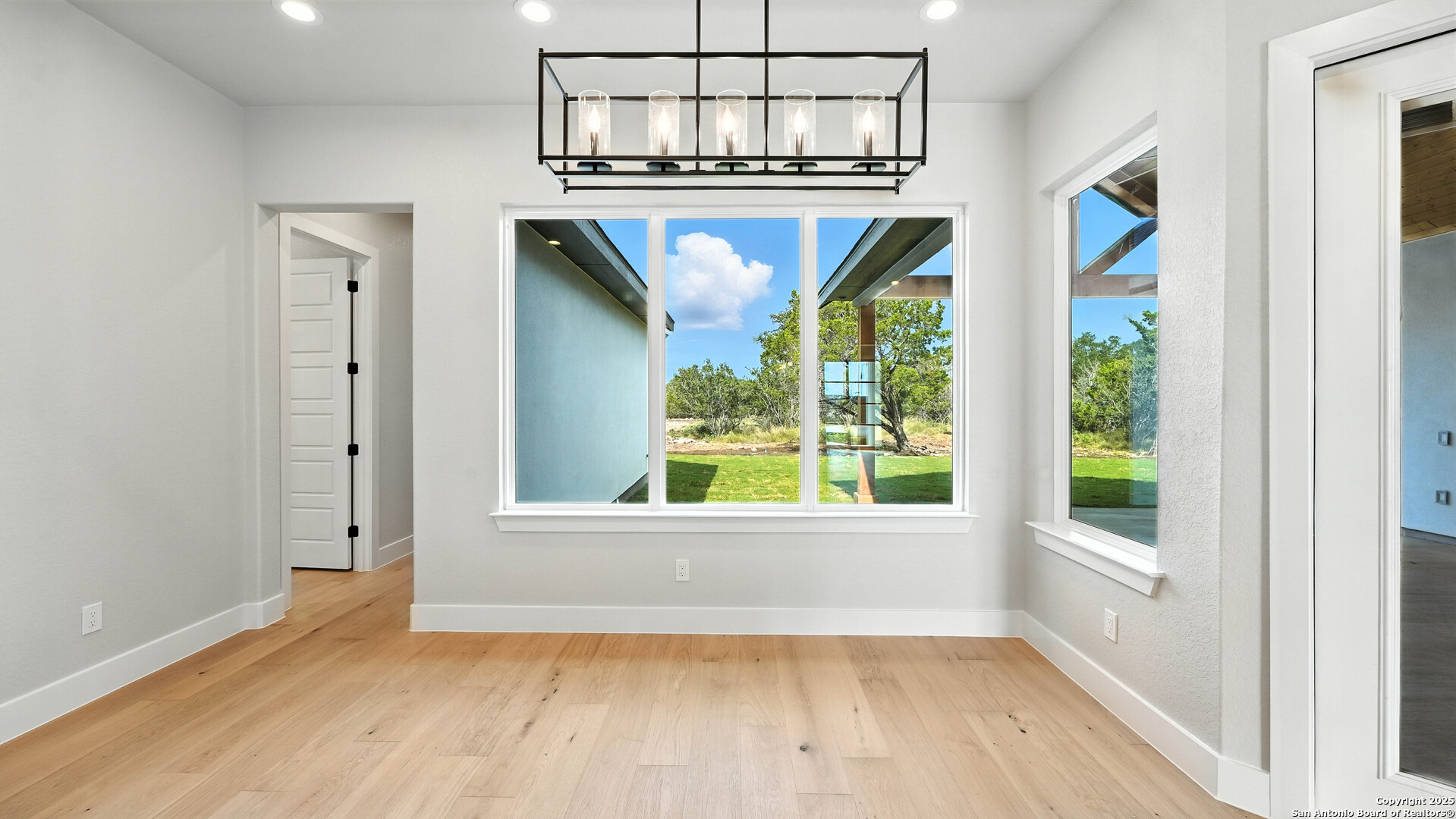 306 Toucan Drive Spring Branch, TX 78070 - Photo 25 of 50 a view of an empty room with a window and wooden floor