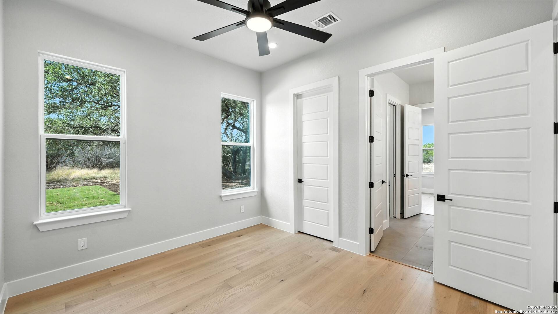 306 Toucan Drive Spring Branch, TX 78070 - Photo 27 of 50 wooden floor in an empty room with a window