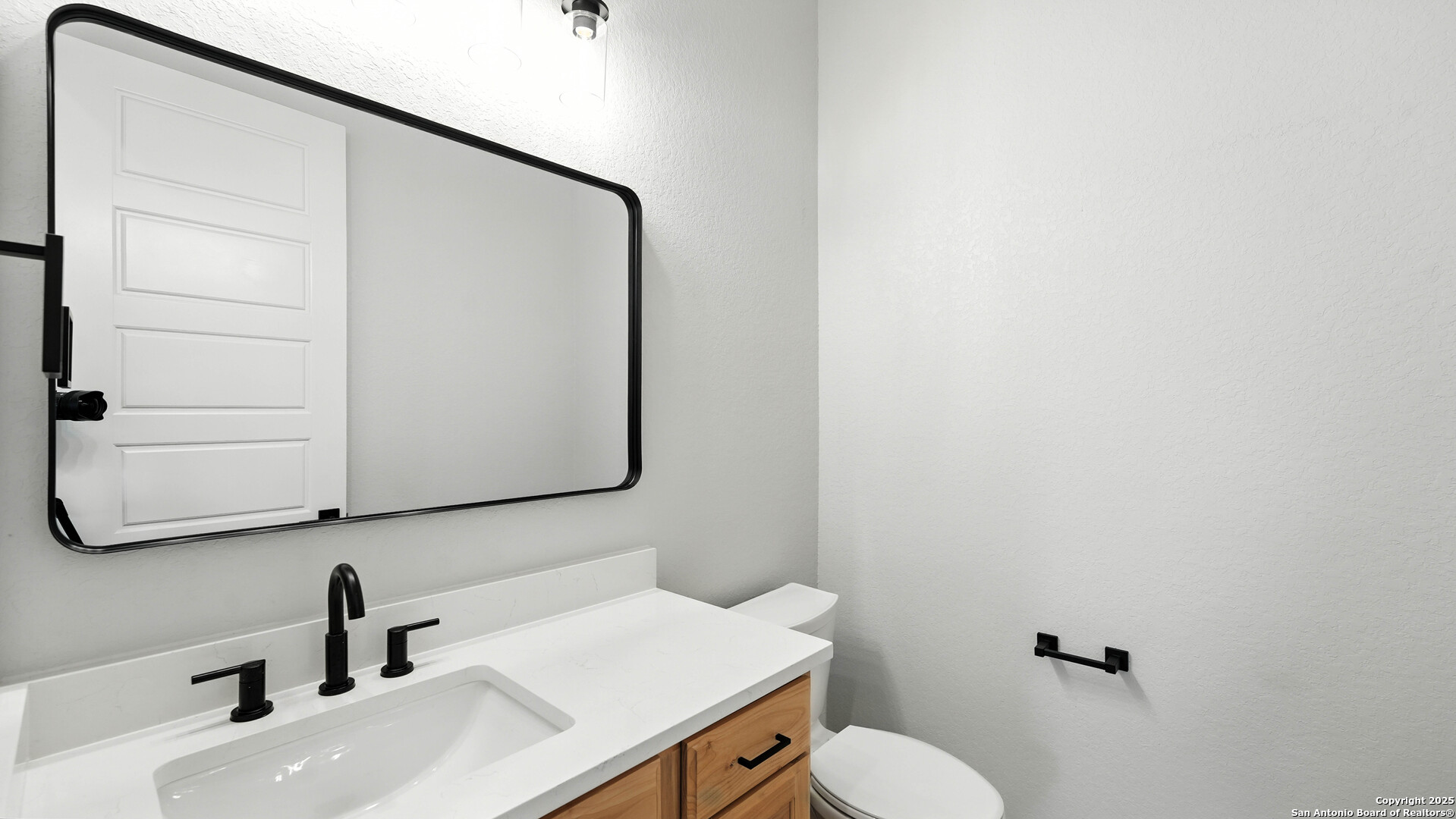 306 Toucan Drive Spring Branch, TX 78070 - Photo 35 of 50 a bathroom with a sink a toilet and mirror