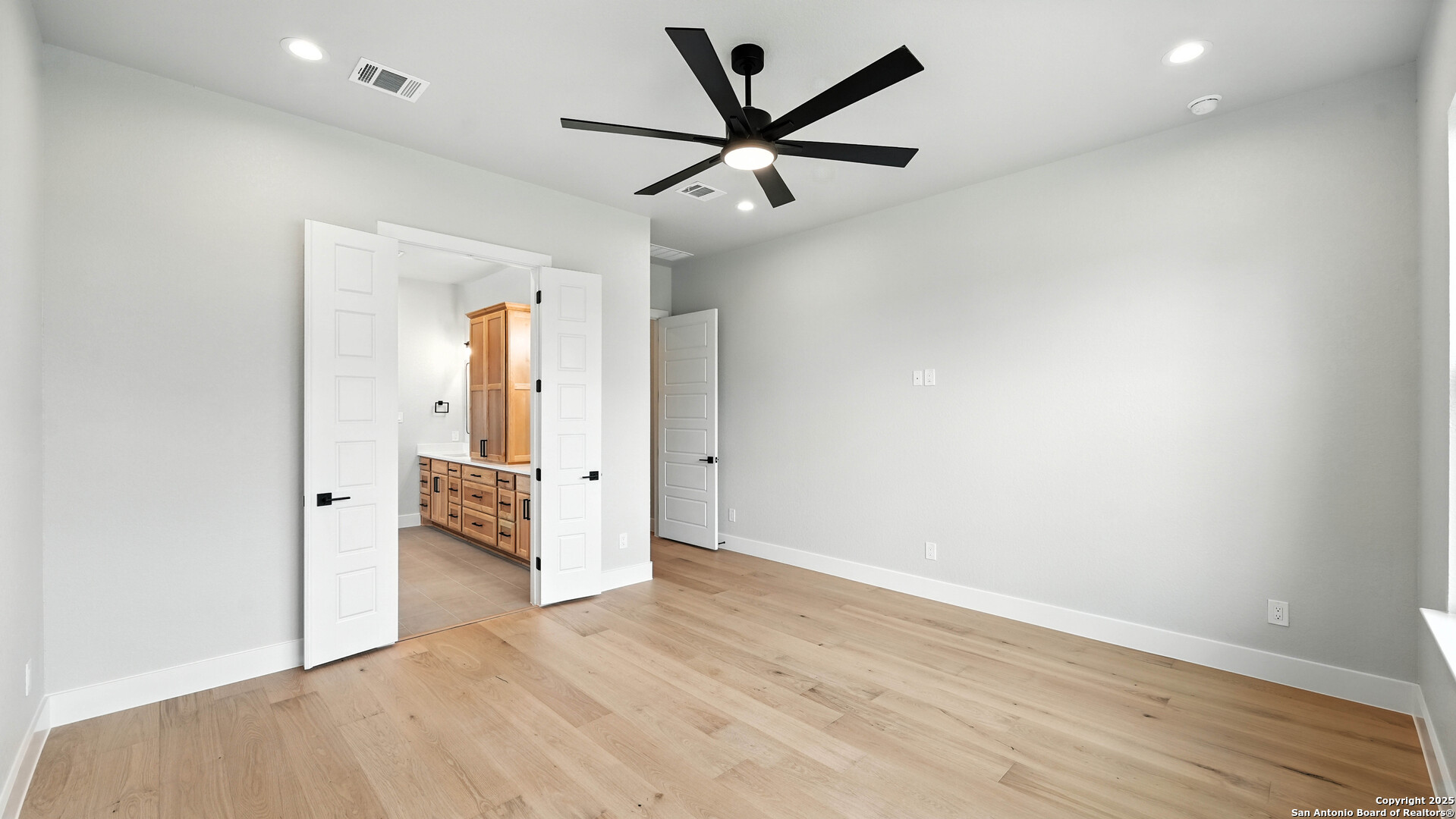 306 Toucan Drive Spring Branch, TX 78070 - Photo 37 of 50 an empty room with wooden floor and a ceiling fan