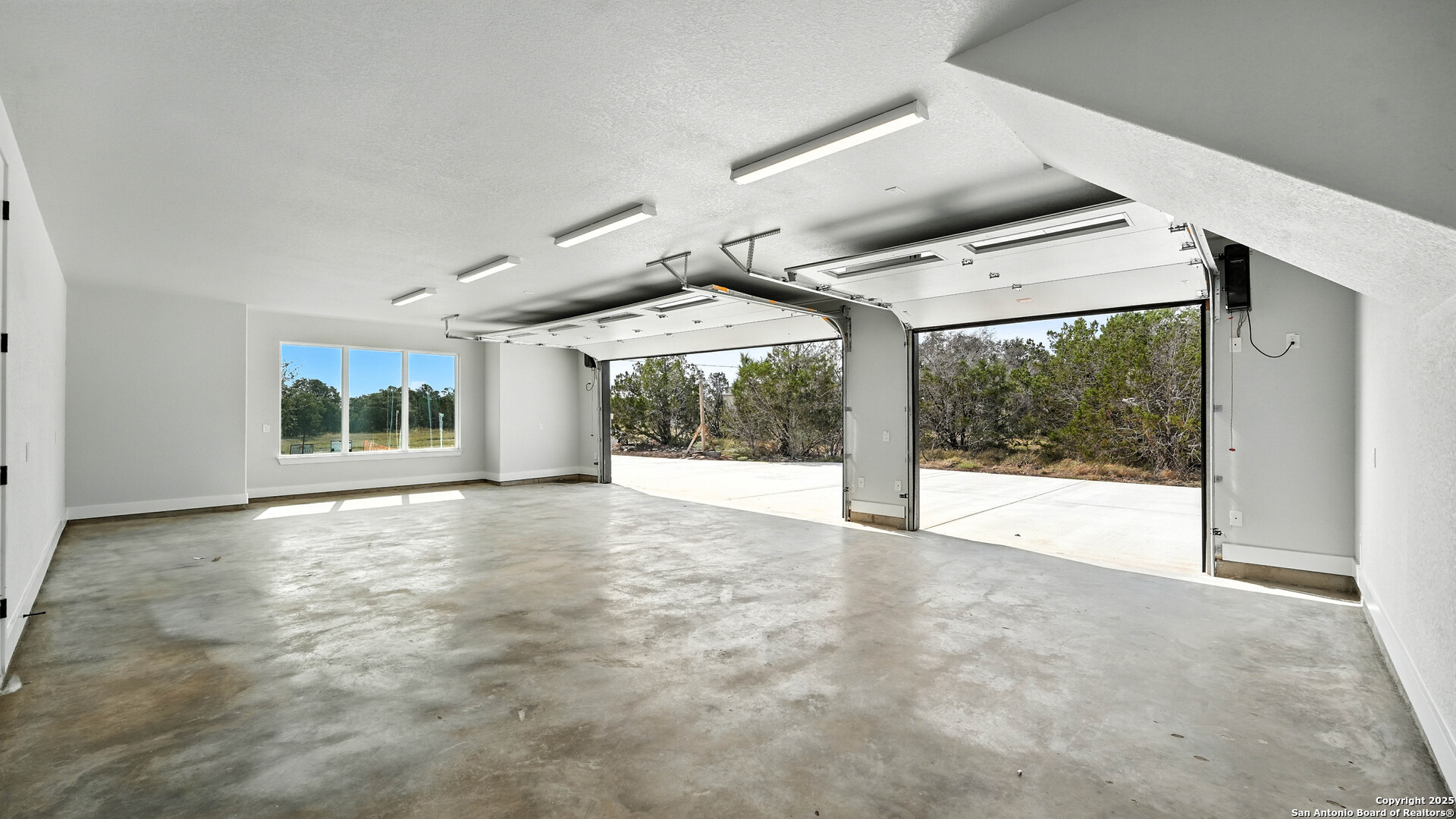306 Toucan Drive Spring Branch, TX 78070 - Photo 43 of 50 a view of an empty room with wooden floor and a large window