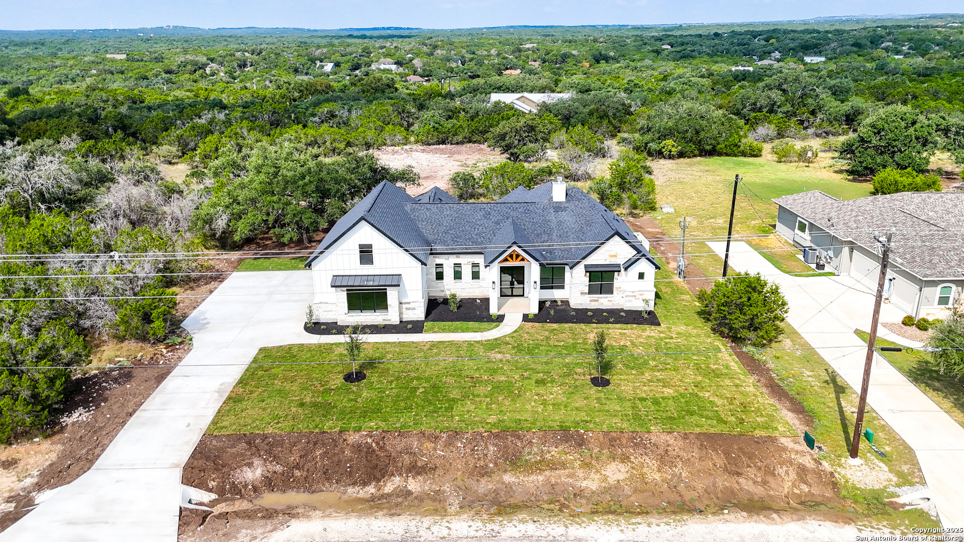 306 Toucan Drive Spring Branch, TX 78070 - Photo 47 of 50 a house with green field in front of it