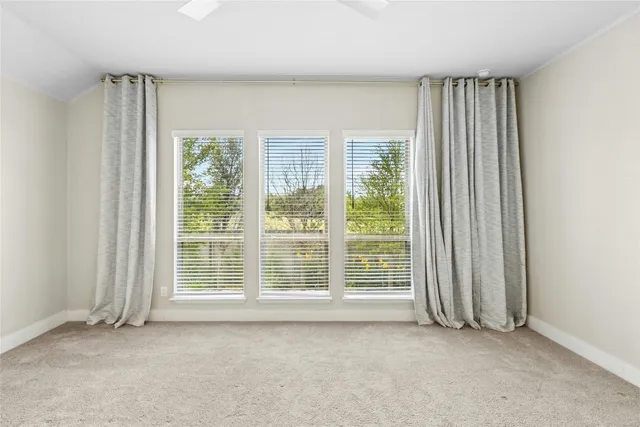 a view of room with window and ceiling fan