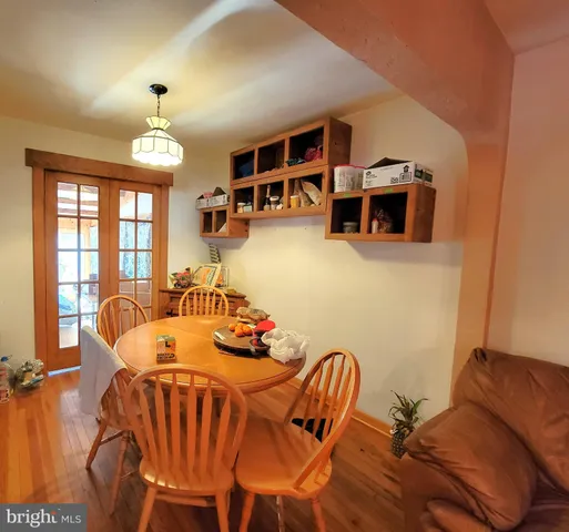 a living room with furniture a chandelier and a flat screen tv