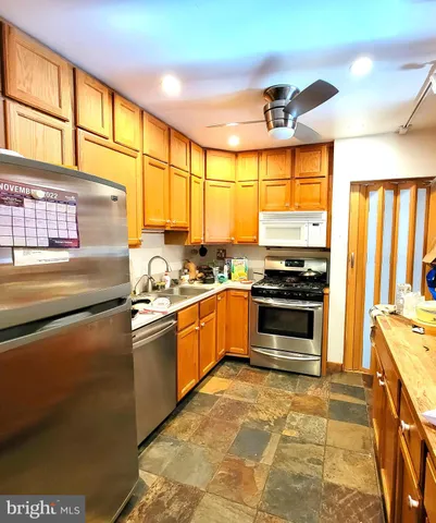 a kitchen with stainless steel appliances granite countertop a stove and a window