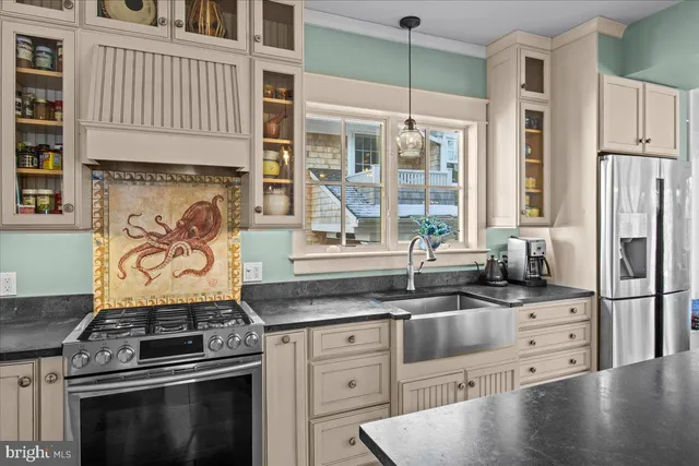 a living room with furniture a chandelier and a fireplace