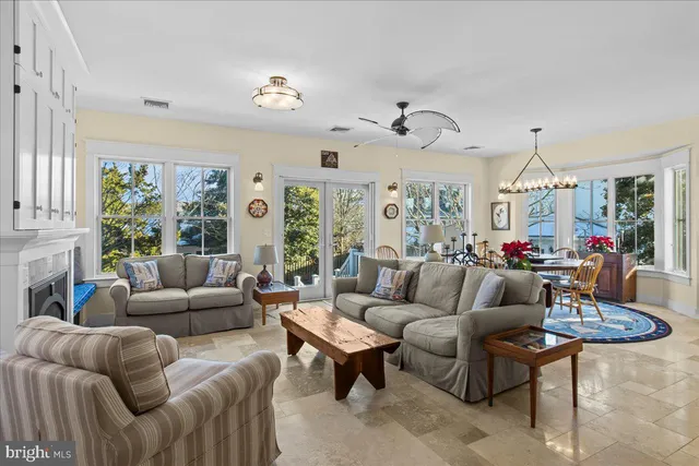 a living room with furniture potted plant and a fireplace