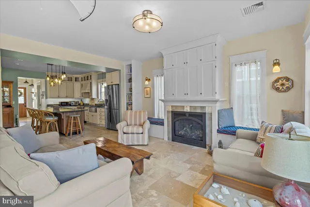 a dining room with furniture a chandelier and wooden floor