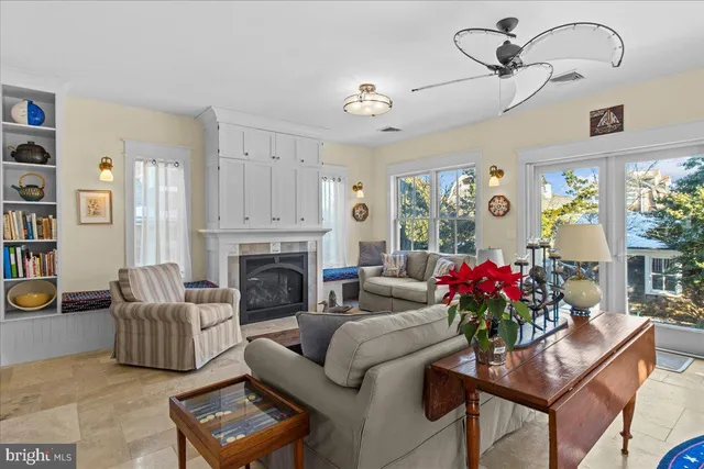 a dining room with wooden floor a chandelier a wooden table and chairs