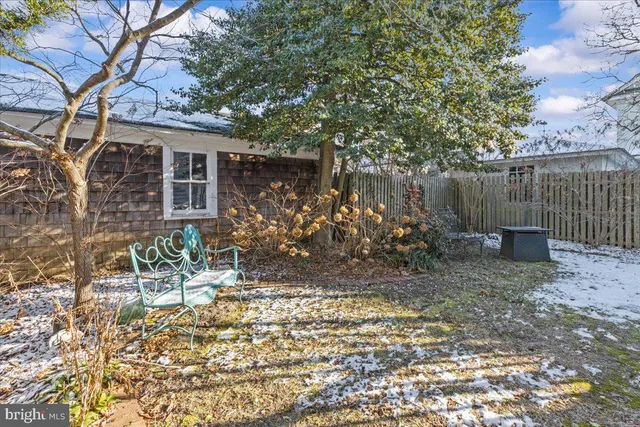a bedroom with a bed wooden floor and window