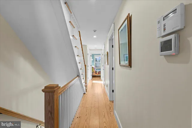 a room with a baby crib and a book shelf