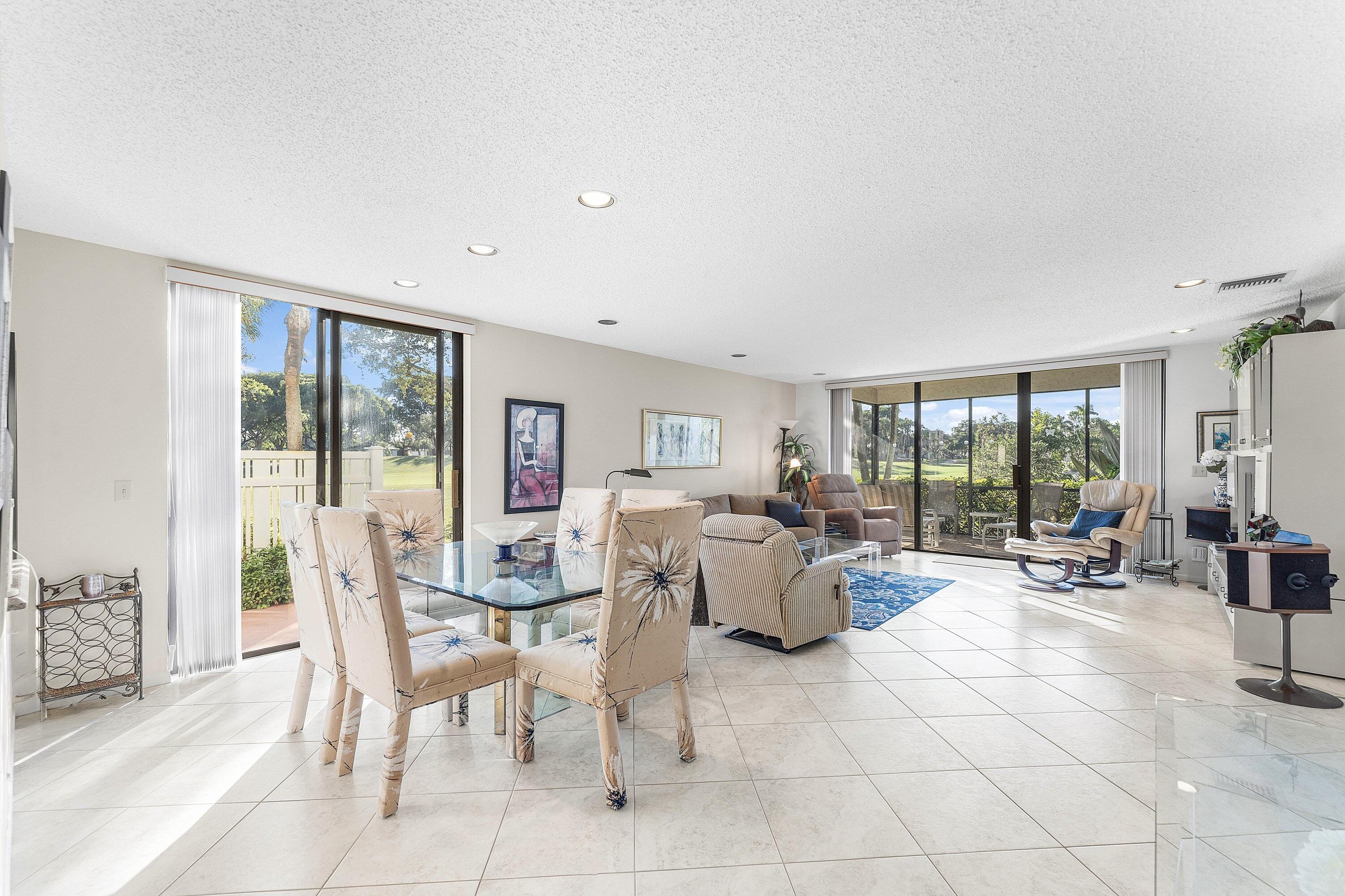 a living room with fireplace furniture and floor to ceiling window