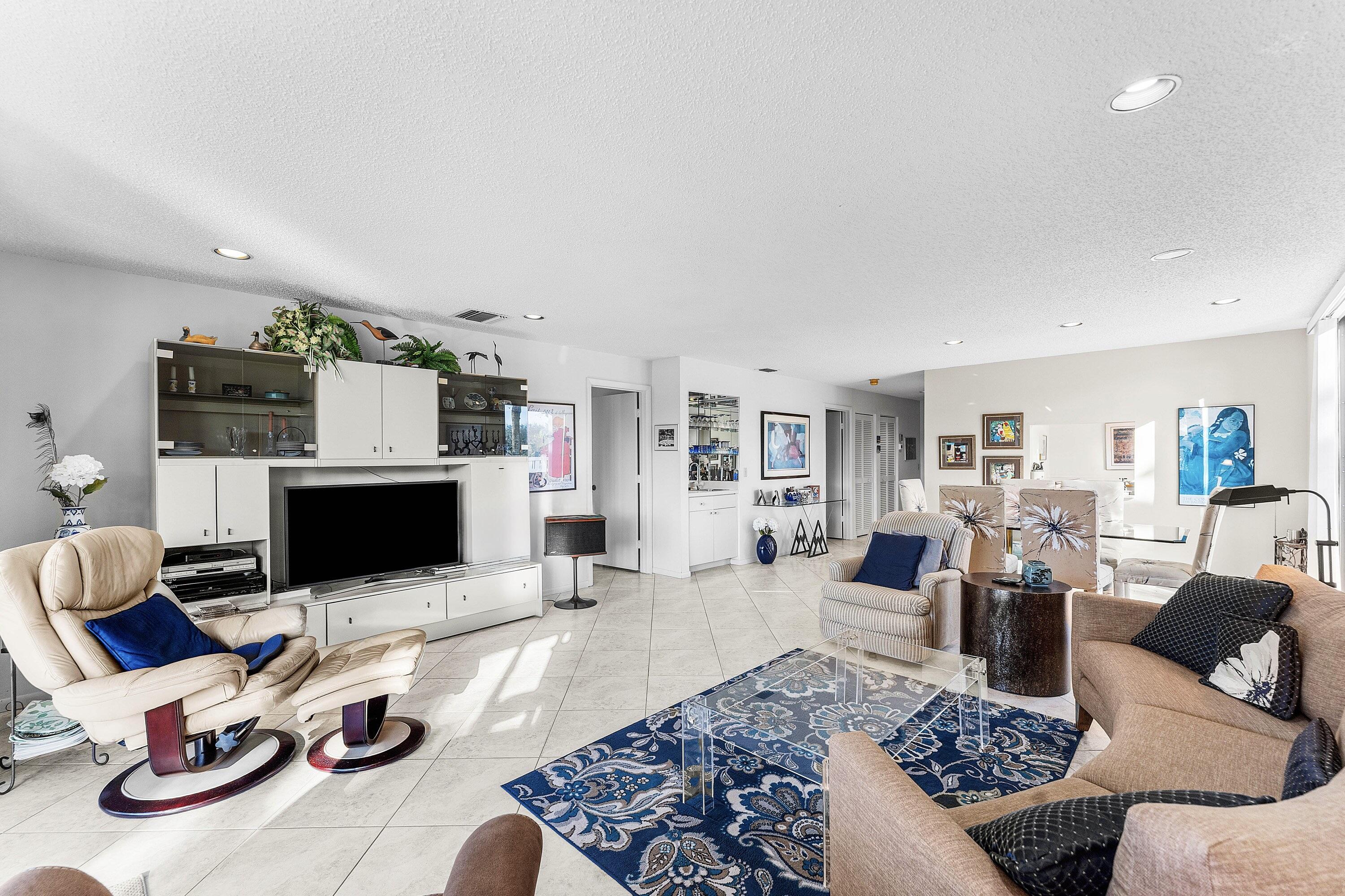 61 Eastgate Drive, Unit A Boynton Beach, FL 33436 - Photo 11 of 54 a living room with furniture and a flat screen tv