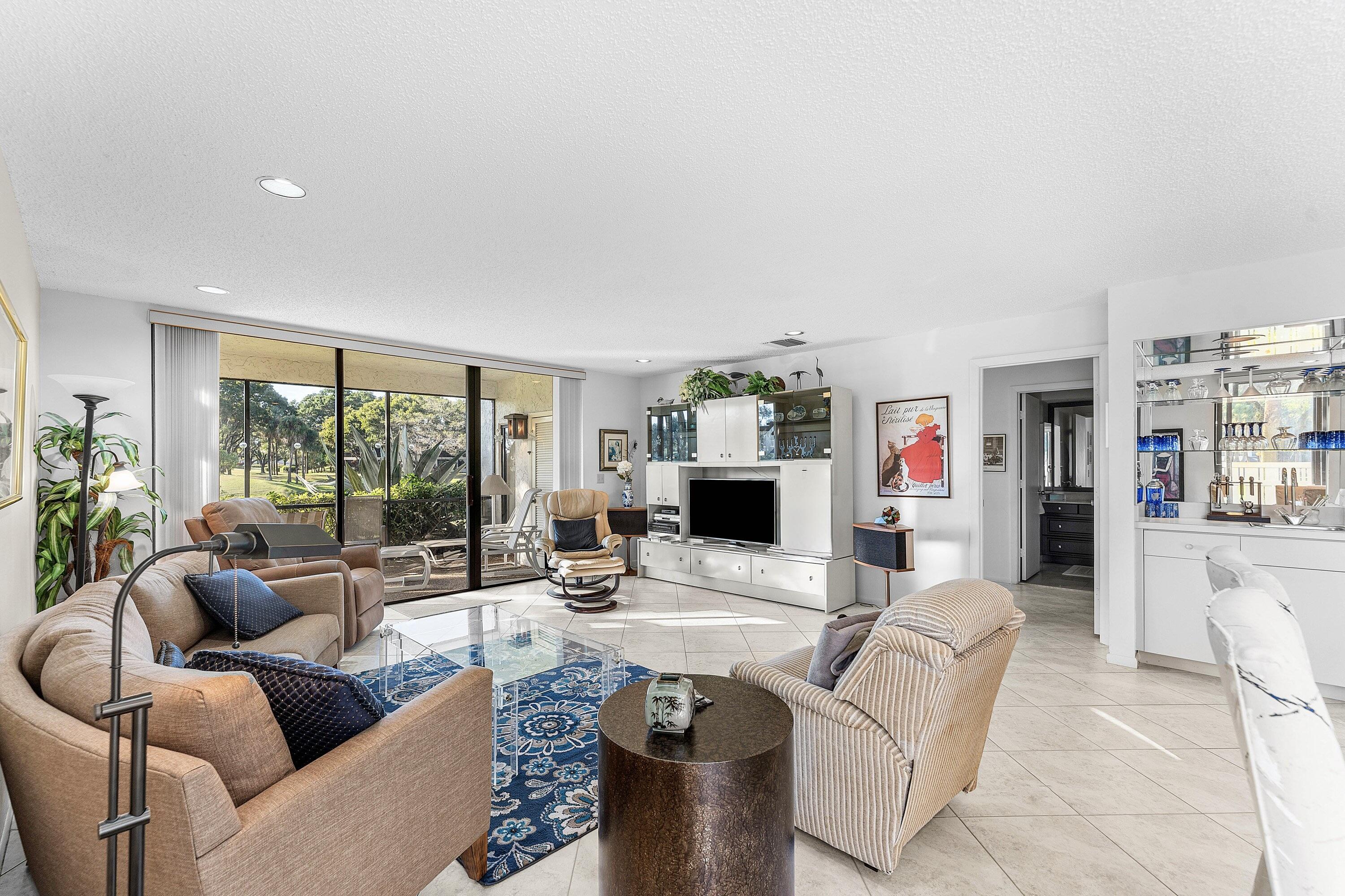 61 Eastgate Drive, Unit A Boynton Beach, FL 33436 - Photo 12 of 54 a living room with furniture and a flat screen tv