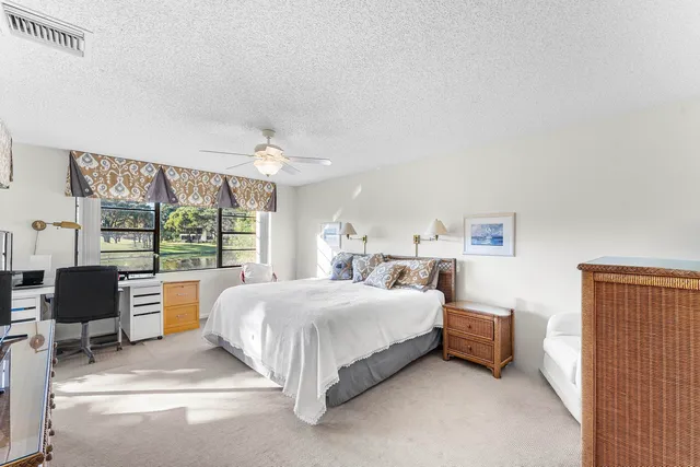 a large bedroom with bed and tv