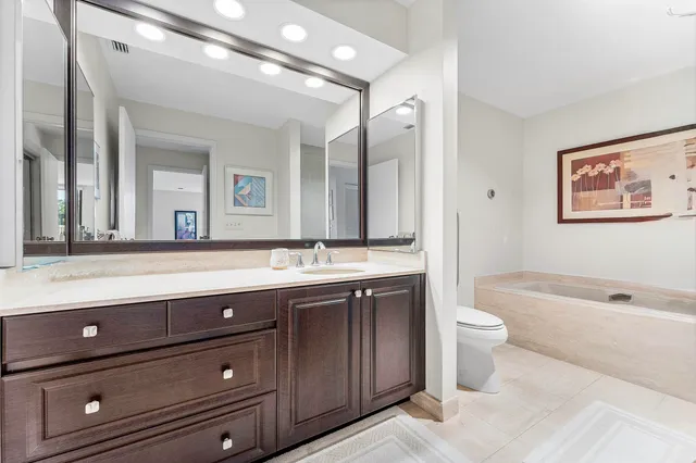 a white bath tub sitting next to a shower