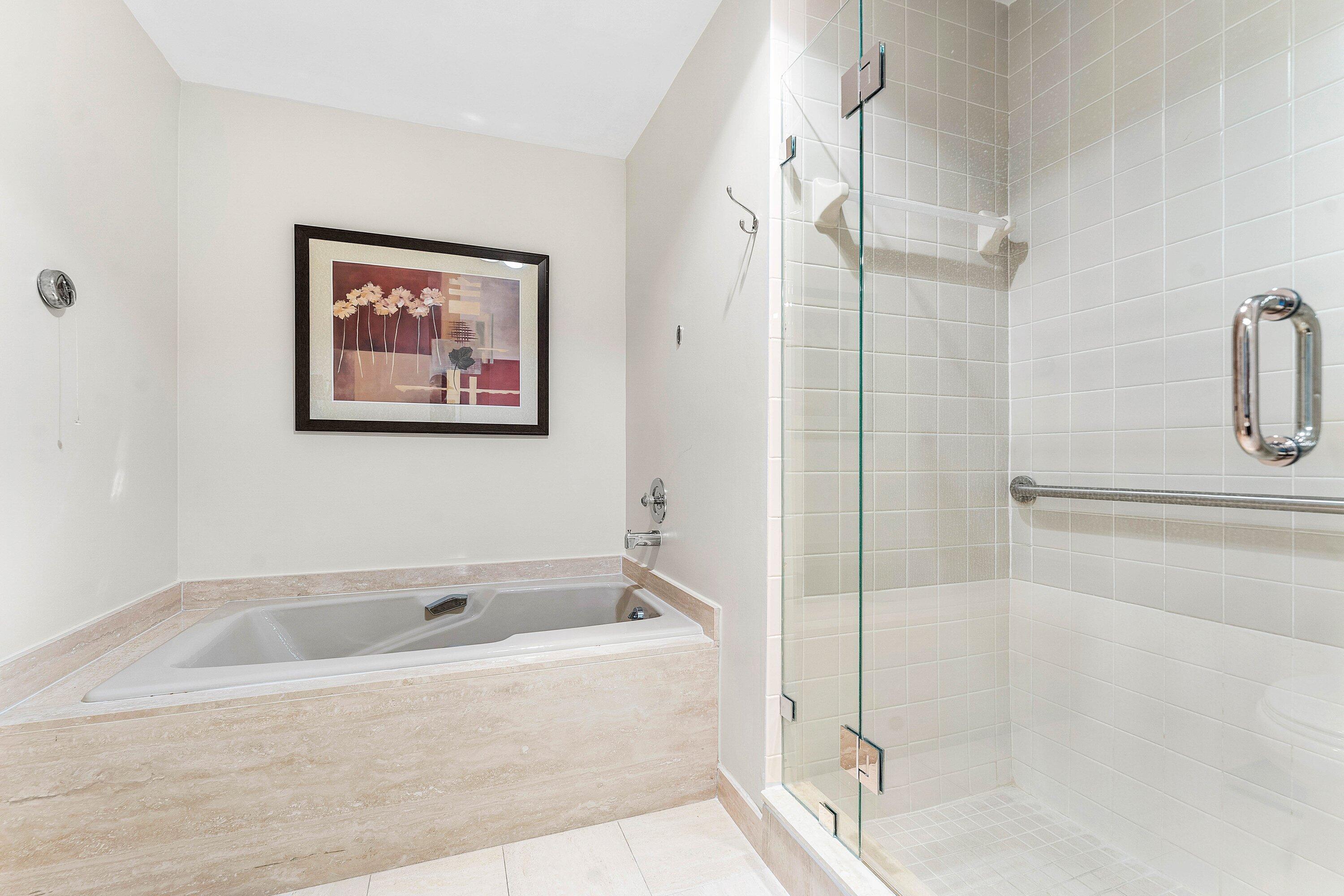 61 Eastgate Drive, Unit A Boynton Beach, FL 33436 - Photo 25 of 54 a white bath tub sitting next to a shower