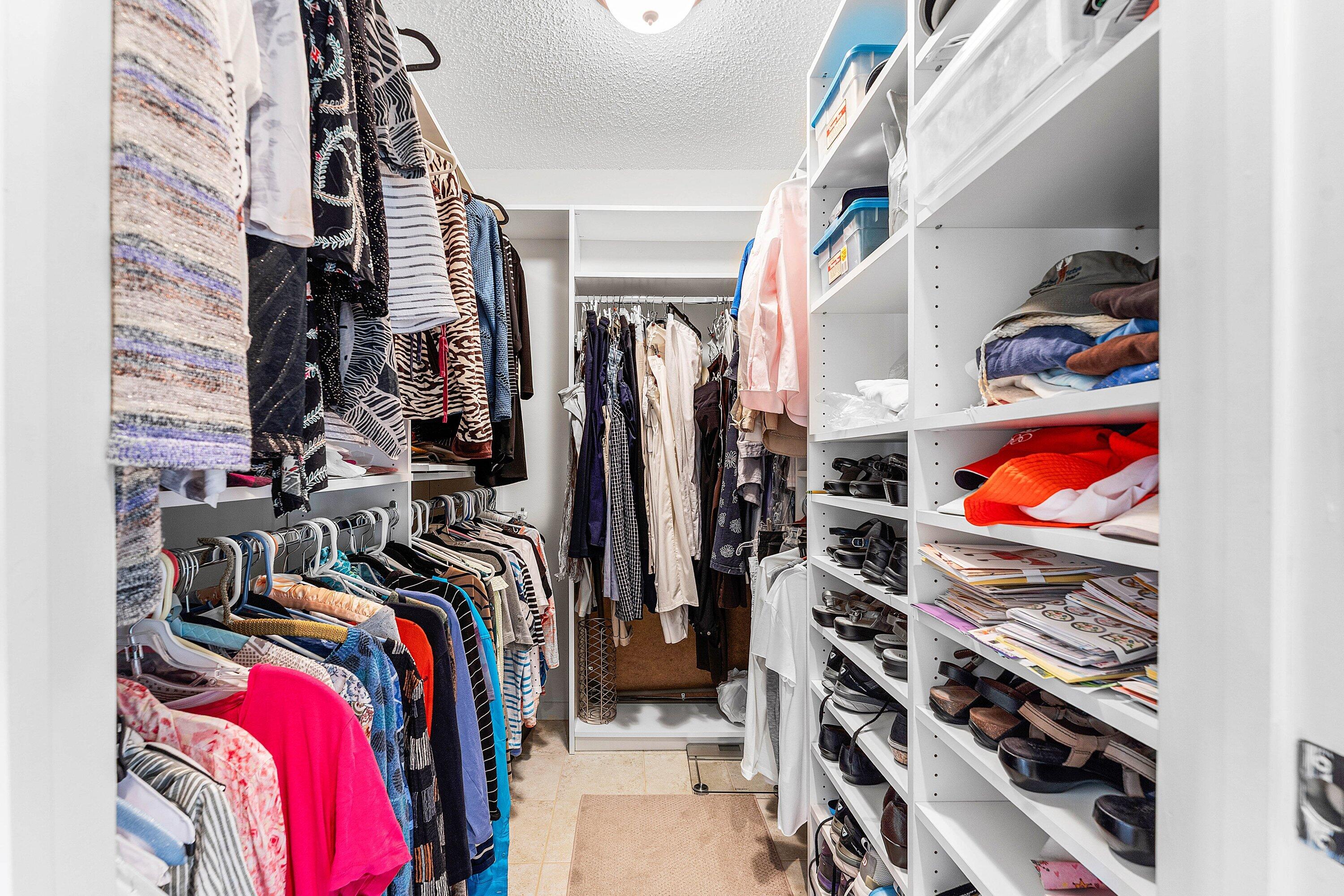 61 Eastgate Drive, Unit A Boynton Beach, FL 33436 - Photo 26 of 54 a view of walk in closet with clothes and shoes