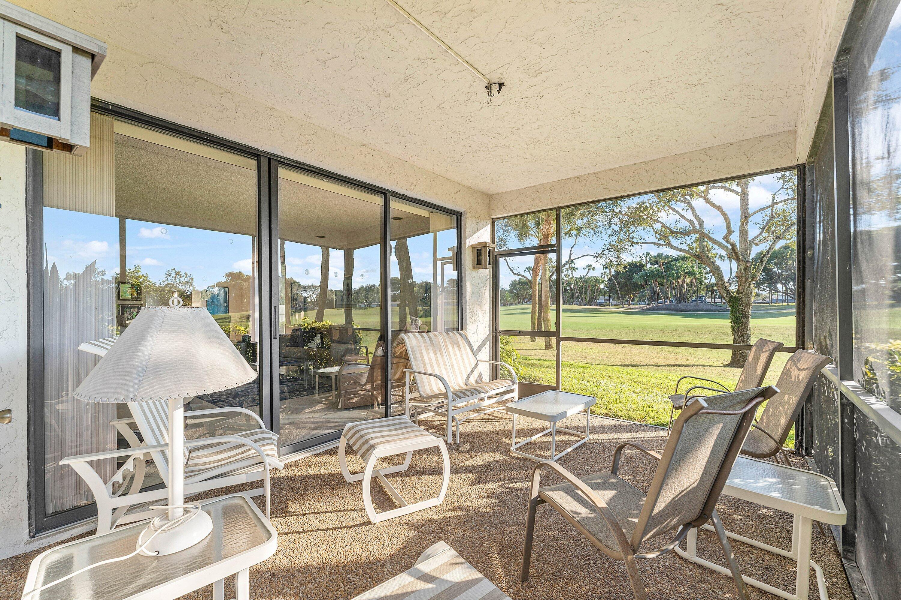 61 Eastgate Drive, Unit A Boynton Beach, FL 33436 - Photo 30 of 54 a view of a dining room with furniture wooden floor and windows