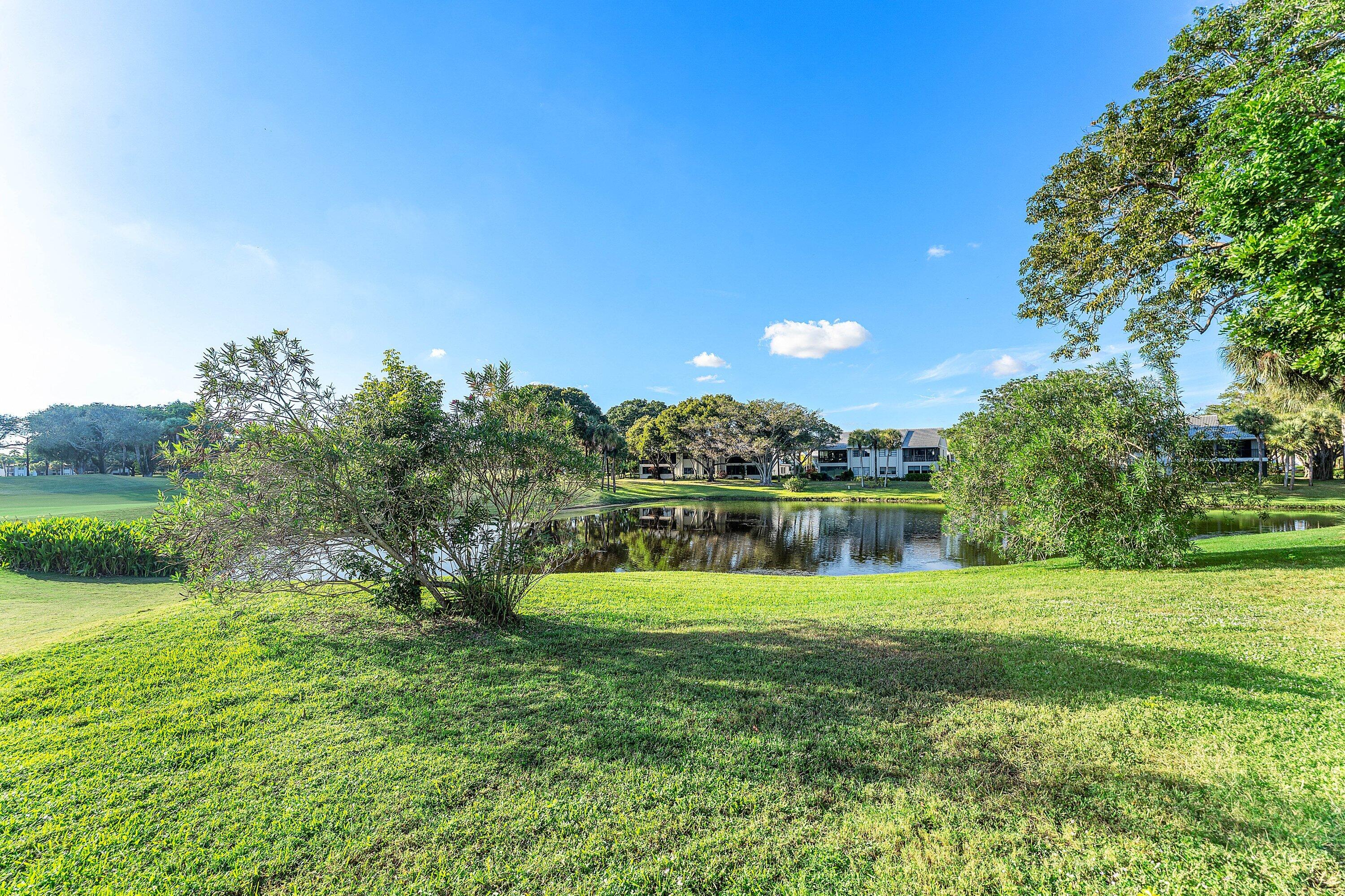 61 Eastgate Drive, Unit A Boynton Beach, FL 33436 - Photo 33 of 54 a view of a golf course with a lake