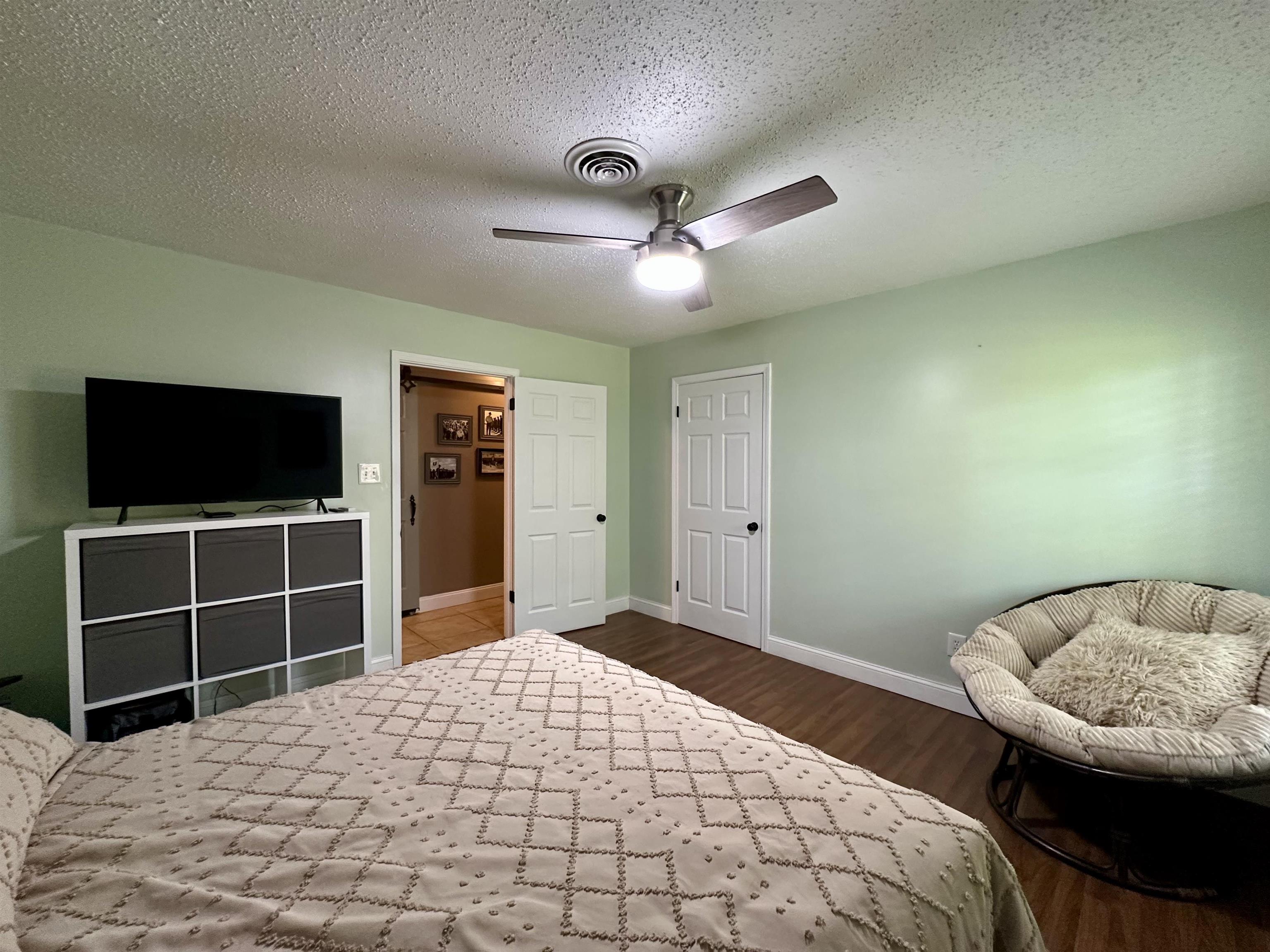 1230 Joann Road Somerville, TN 38068 - Photo 15 of 28 Bedroom with a textured ceiling, dark wood-style flooring, and ceiling fan