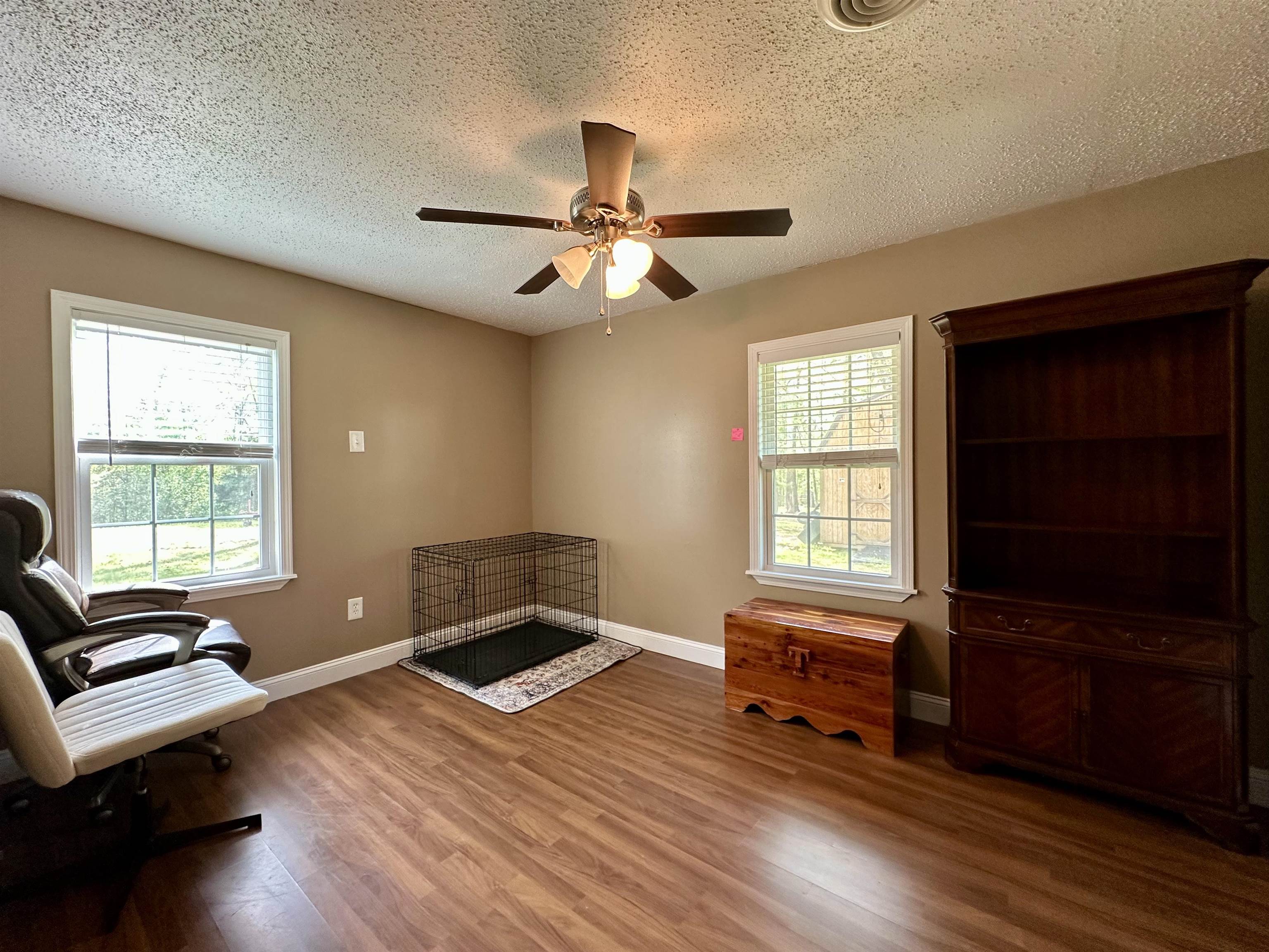 1230 Joann Road Somerville, TN 38068 - Photo 17 of 28 Living area featuring a textured ceiling, dark wood-type flooring, and ceiling fan