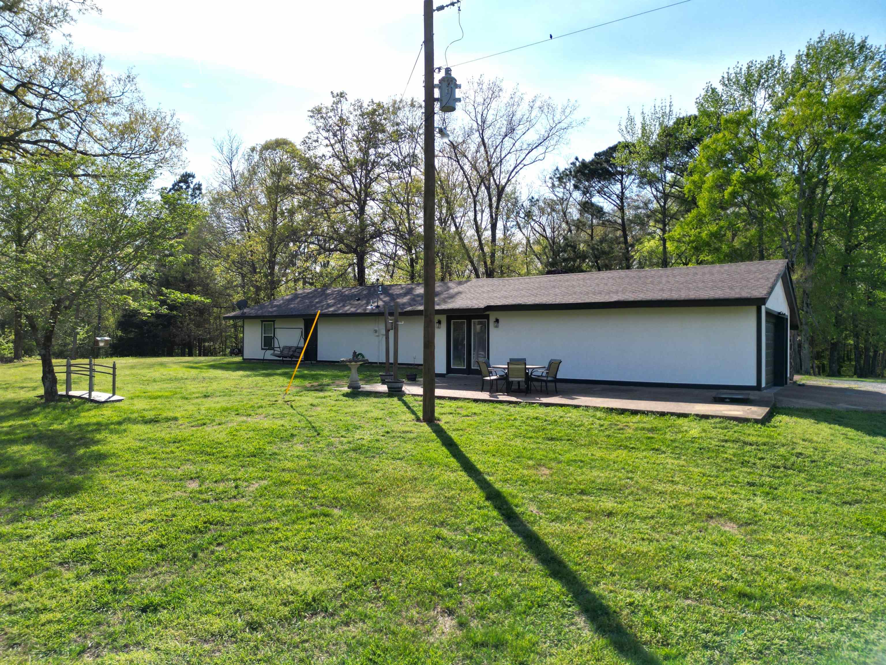 1230 Joann Road Somerville, TN 38068 - Photo 22 of 28 View of front of property featuring a front yard, view of wooded area, a patio, and stucco siding