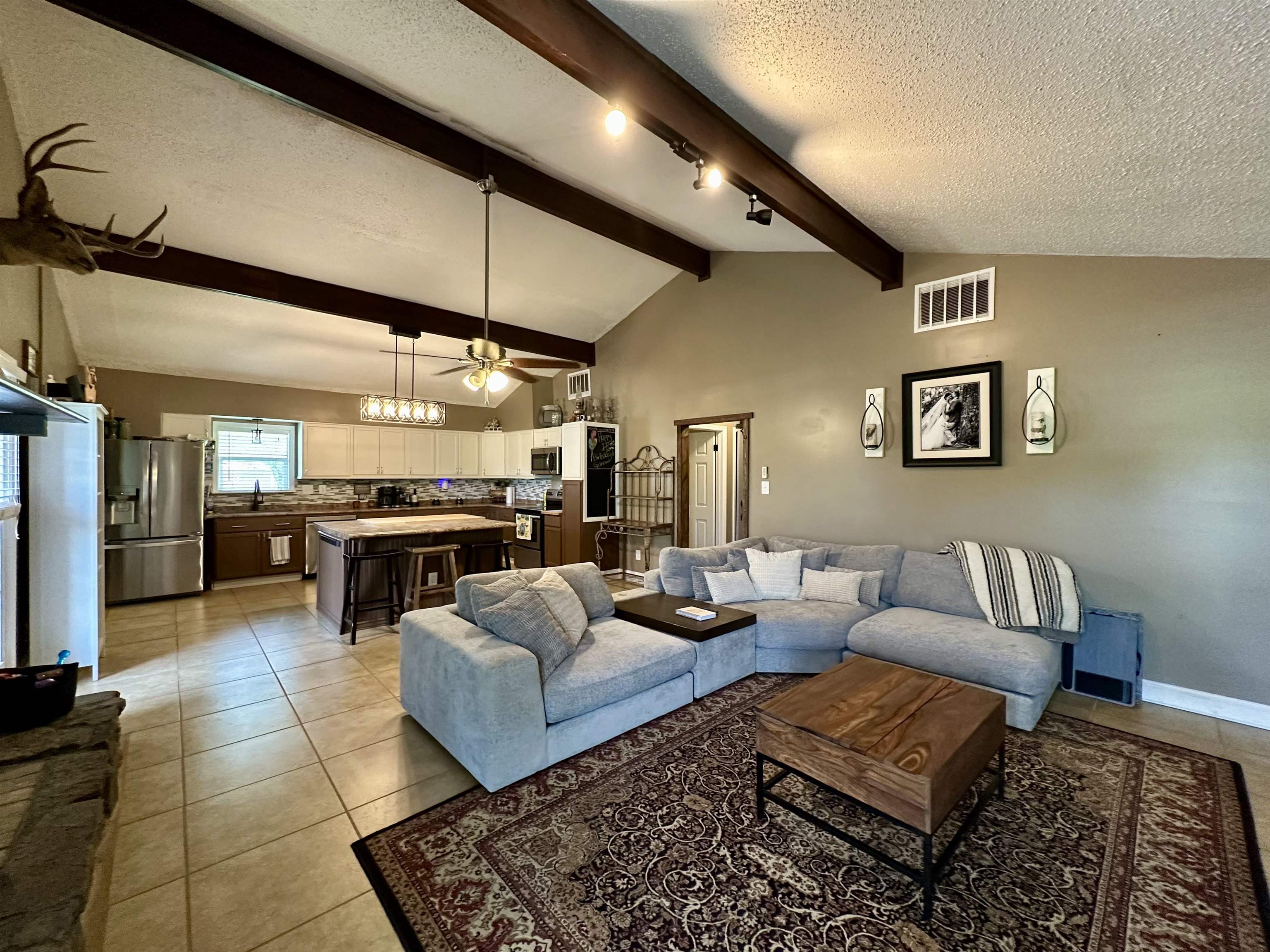 1230 Joann Road Somerville, TN 38068 - Photo 5 of 28 Living room featuring ceiling fan, light tile patterned floors, and beamed ceiling