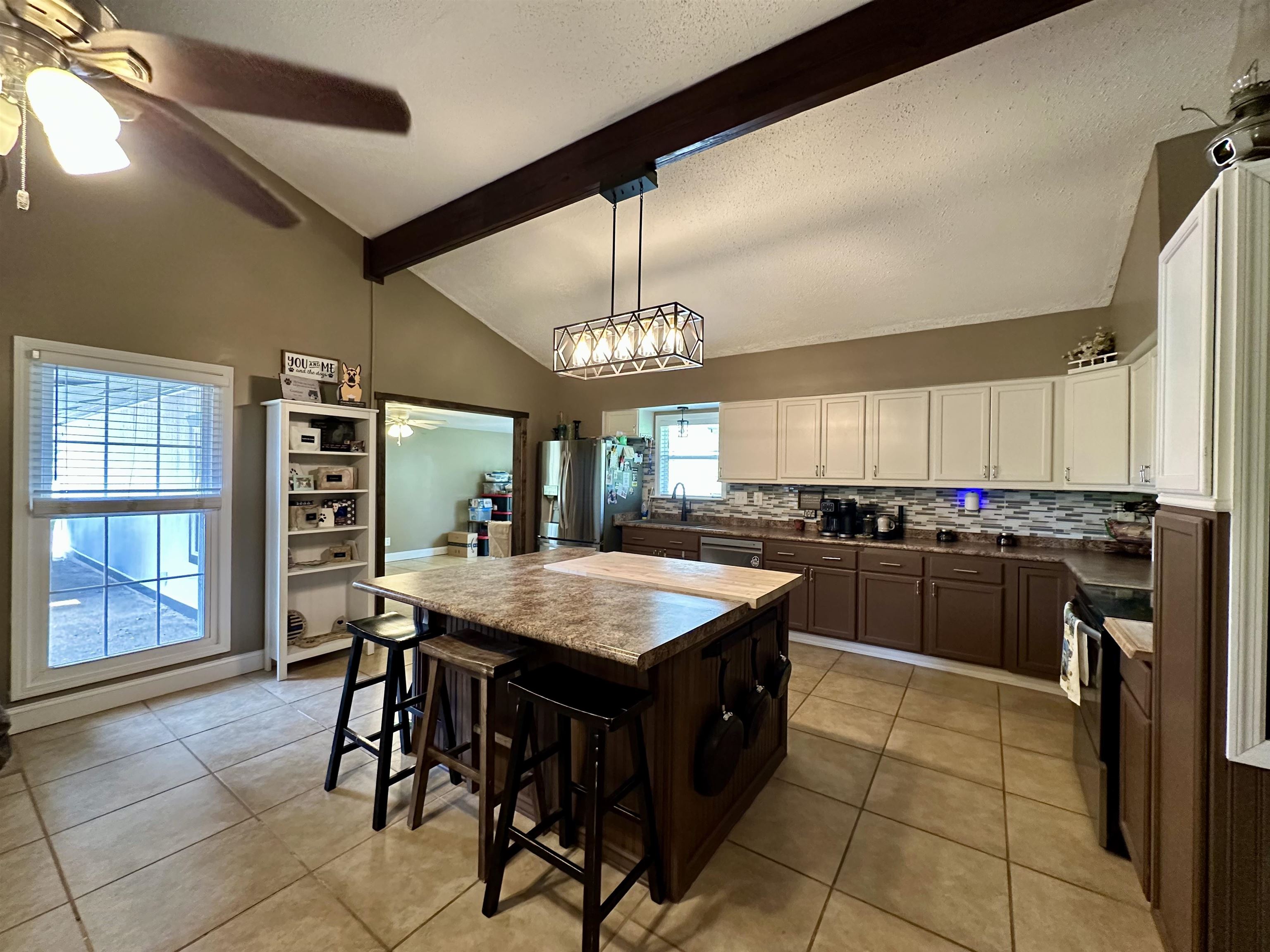 1230 Joann Road Somerville, TN 38068 - Photo 7 of 28 Kitchen with backsplash, two tone cabinetry, a breakfast bar area, a ceiling fan, and stainless steel appliances
