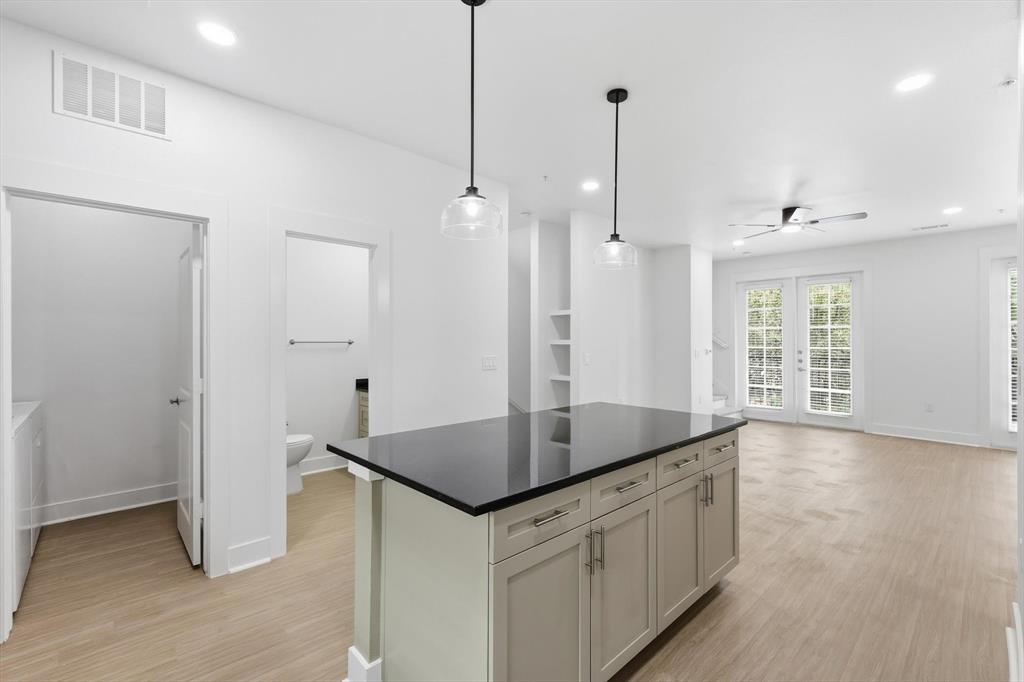 4110 Fairmount Street, Unit 1004 Dallas, TX 75219 - Photo 11 of 35 a kitchen with stainless steel appliances granite countertop a sink a refrigerator and a granite counter tops