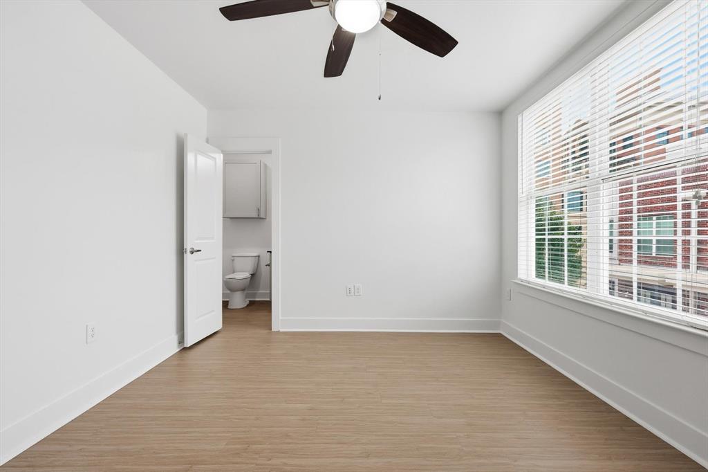4110 Fairmount Street, Unit 1004 Dallas, TX 75219 - Photo 18 of 35 an empty room with a window and a ceiling fan